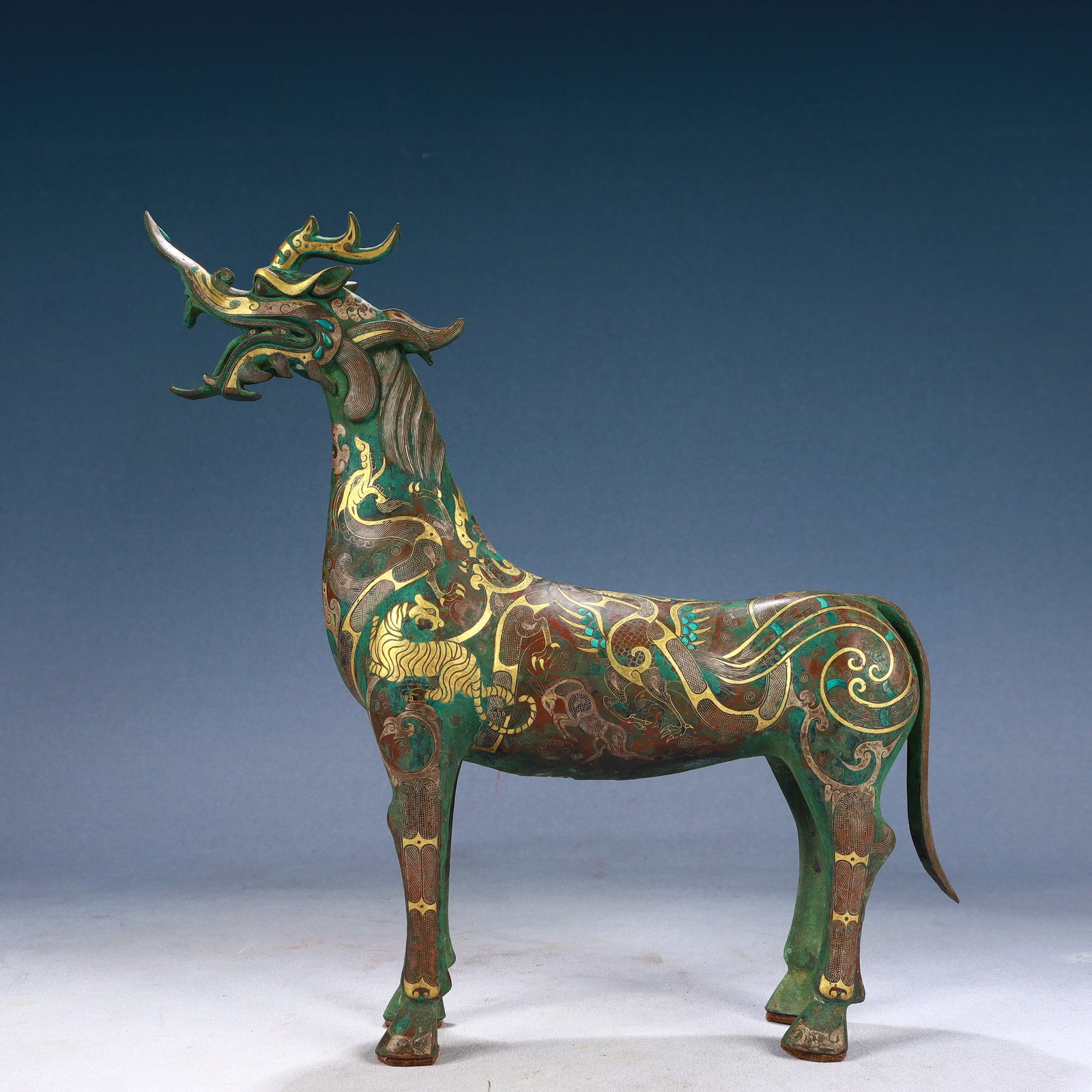 An Archaic Bronze Inlaid Gold and Silver Auspicious Beast Pattern Unicorn Ornament: An Archaic Bronze Inlaid Gold and Silver Auspicious Beast Pattern Unicorn Ornament,Qing Dynasty, China,Size:12.6inx2.8inx13.4in,Weight:2800g 青铜错金银瑞兽