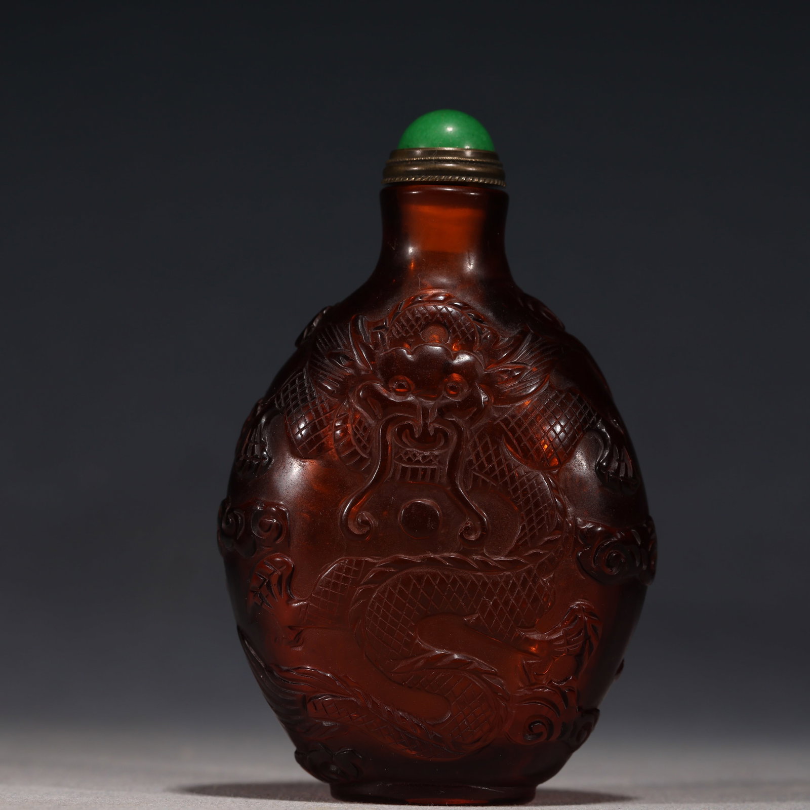 An Exquisite Tea-colored Glass Relief Cloud Dragon Playing Pearl Pattern Snuff Bottle (1 of 5)