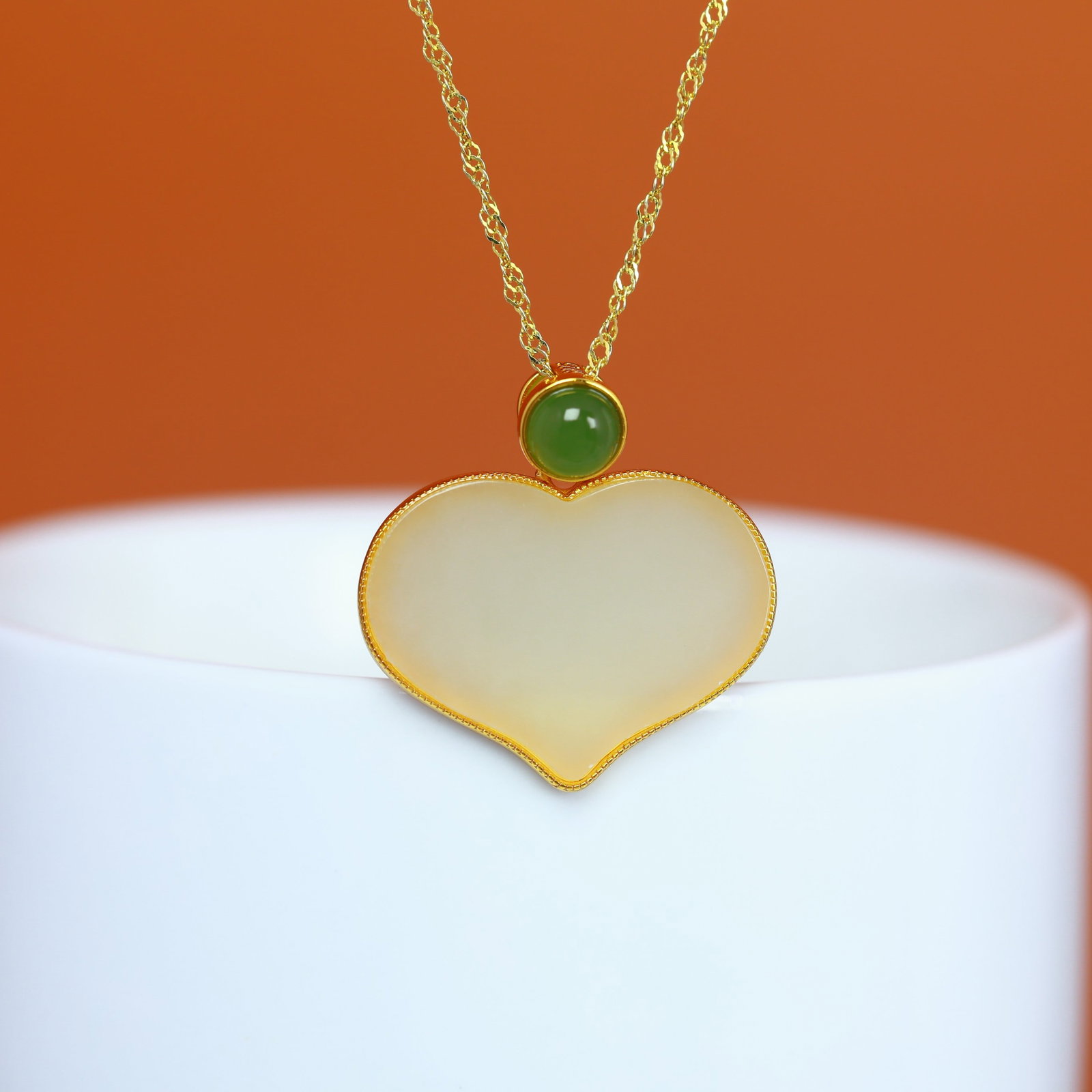 A Sterling Silver and White Jade Heart Pendant: A sterling silver pendant set with a white jade heart, Sise: 17mm×23 mm.