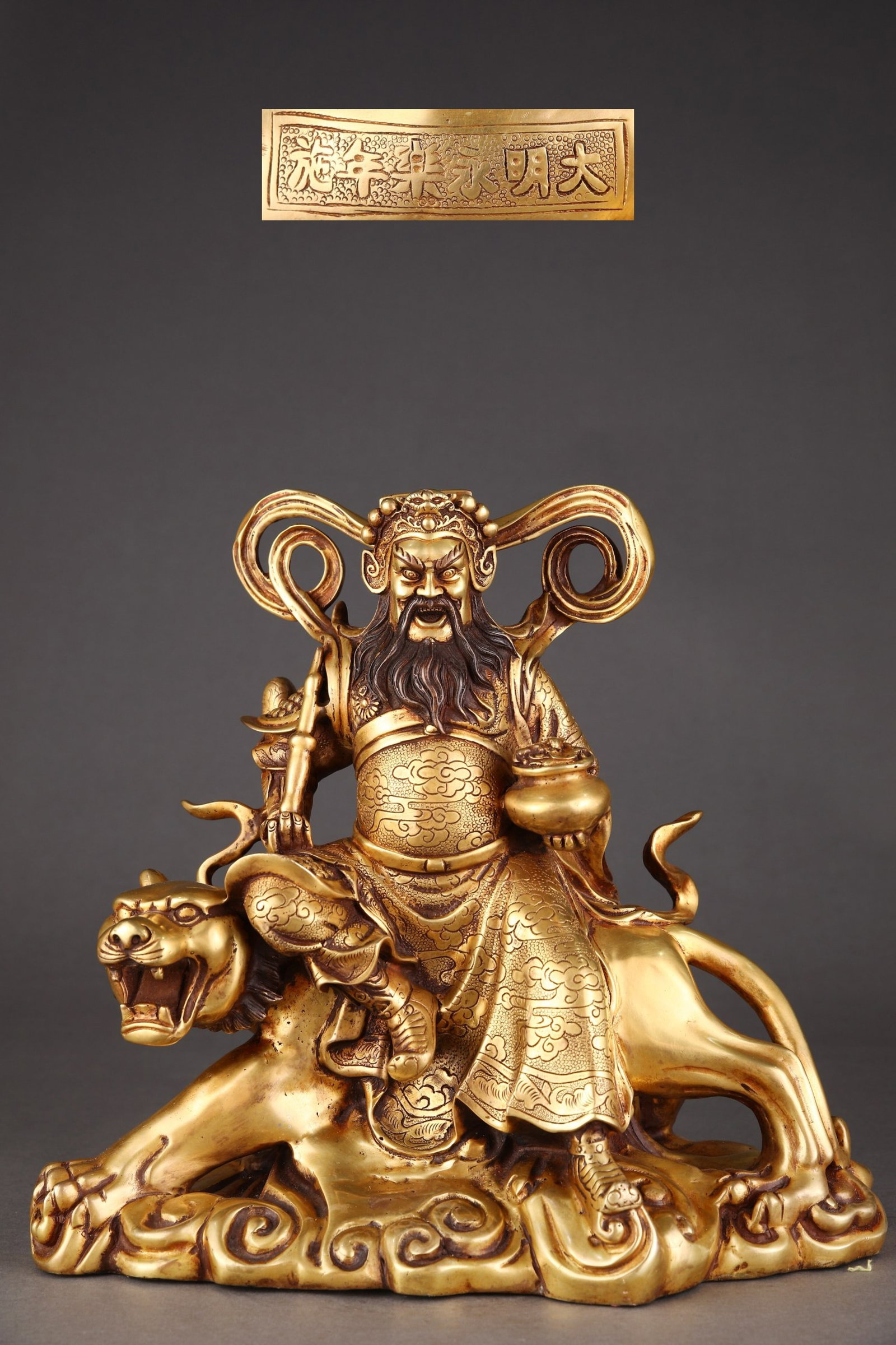 A Solemn Gilt Bronze Auspicious Cloud Pattern Buddha Statue Rides the Tiger: A Solemn Gilt Bronze Auspicious Cloud Pattern Buddha Statue Rides the Tiger,Ming Dynasty,China,Yongle Six-character Mark,Size:11.4inx12.4in,Weight:10350g