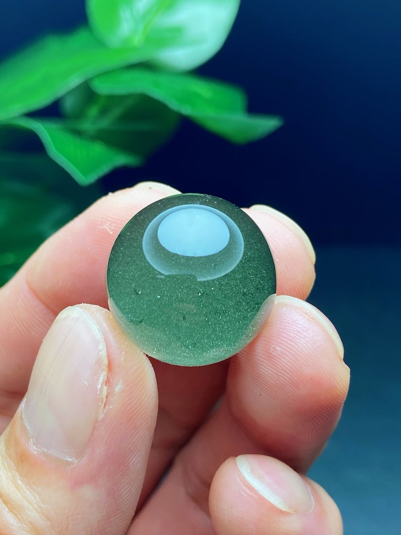 An Exquisite Natural Zambian Green Phantom Treasure Bowl Bead: An Exquisite Zambian Green Phantom Treasure Bowl Bead. Translucent crystal enclosing a green phantom treasure bowl landscape, wearable as a pendant or matched into a multi-stone bracelet. Diameter 20.
