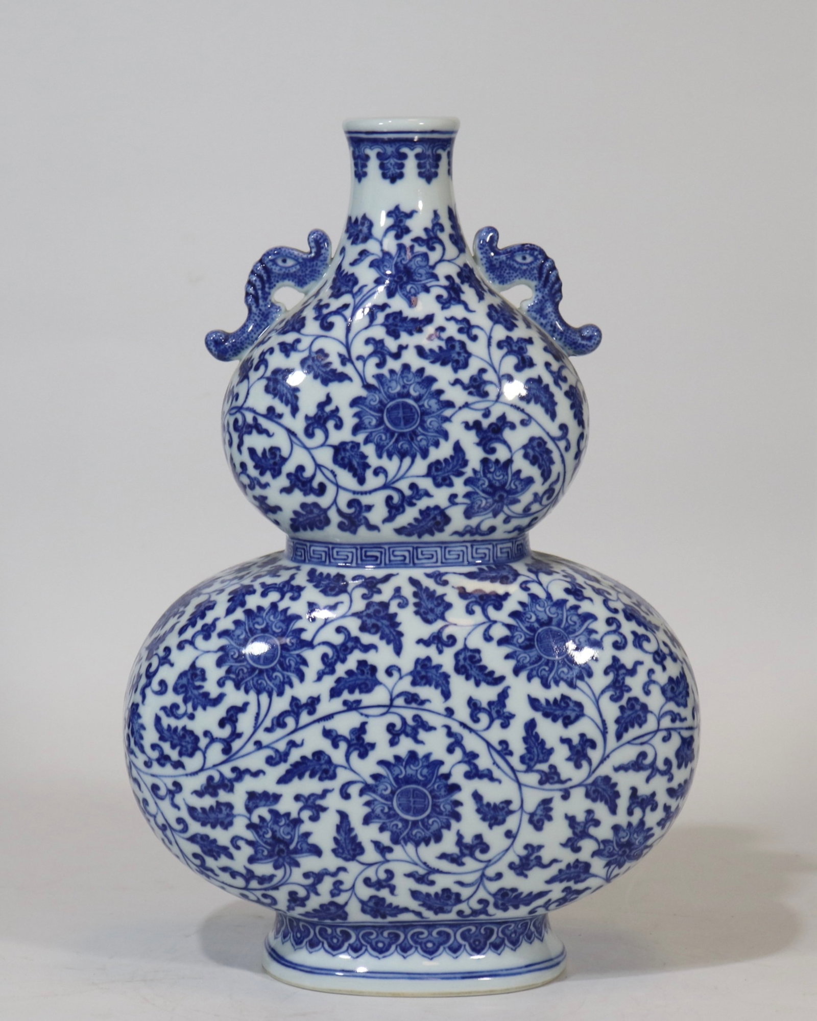 A fine blue and white flat double-gourd vase with double handles and scrolling floral pattern: A fine blue and white flat double-gourd vase with double handles and scrolling floral pattern, Qing Dynasty, China, with six-character Qianlong reign mark, Size:13.5inx8.5in 青花缠&#