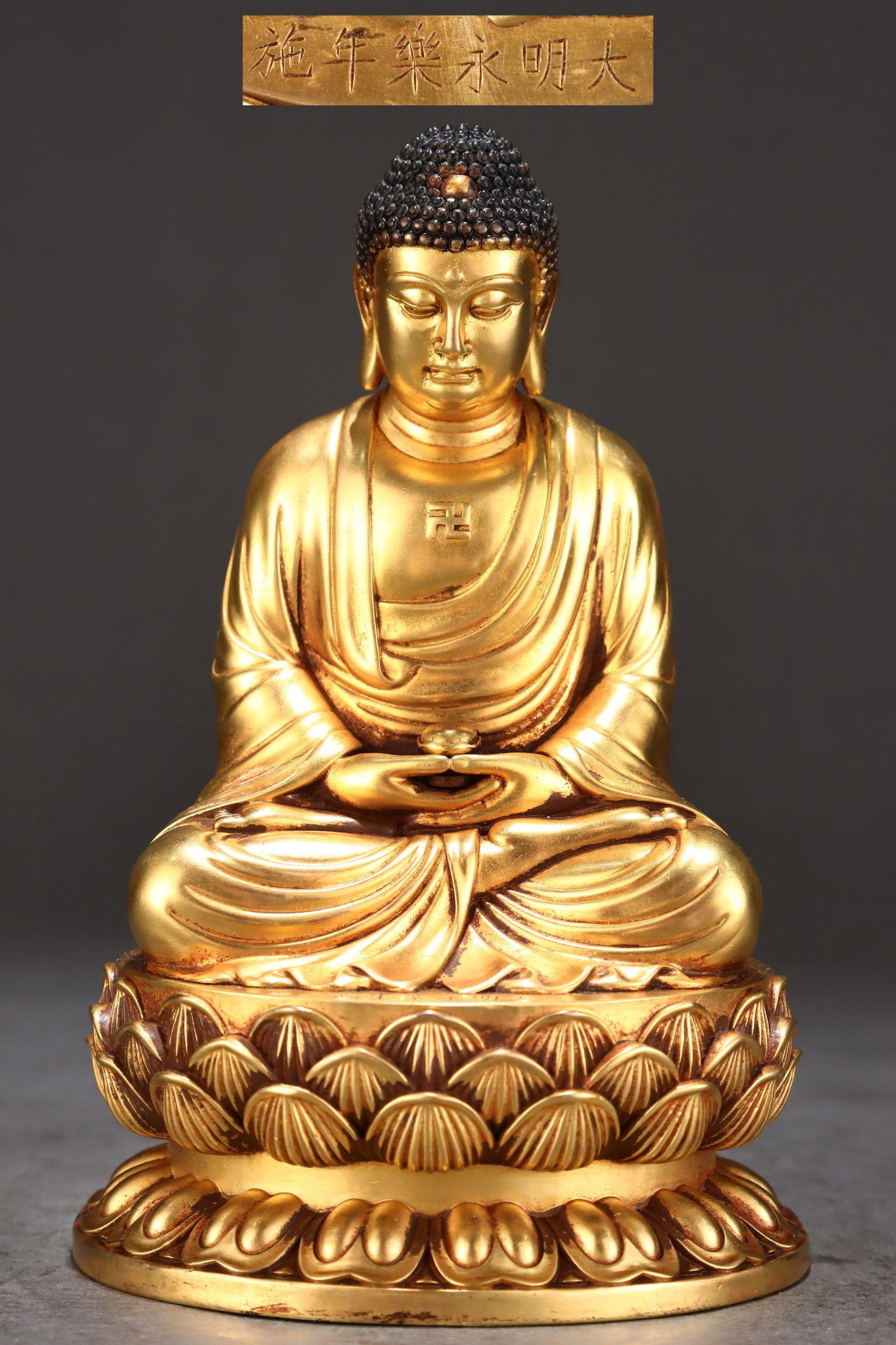 A Solemn Gilt Bronze Statue of Sakyamuni: A Solemn Gilt Bronze Statue of Sakyamuni,Ming Dynasty,China,Yongle Six-character Mark,Size:6.5inx4.1in,Weight:1800g