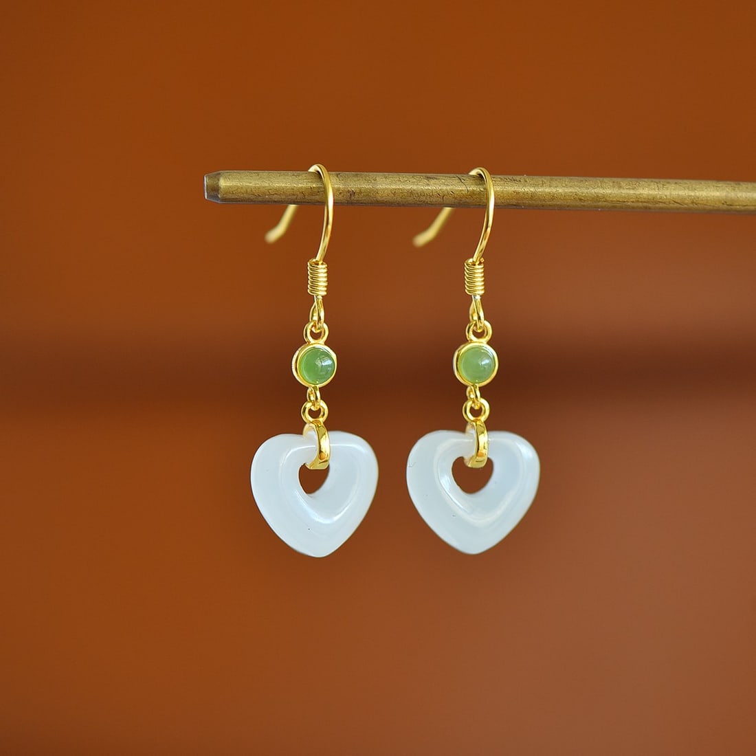 A Pair of Sterling Silver and White Jade Heart Hook Earrings: A pair of sterling silver hook earrings, each set with a white jade heart, Sise: 11mm×12 mm.