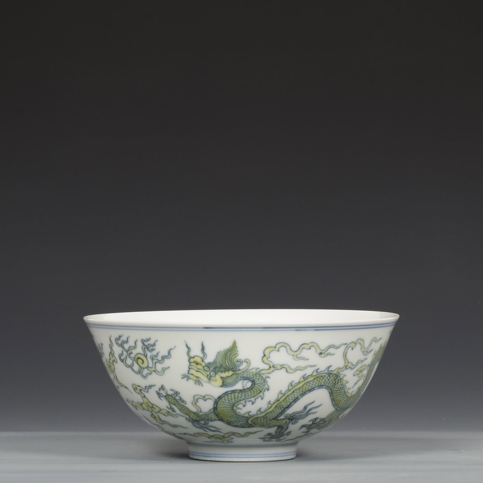 An Exquisite Yellow Glazed Auspicious Cloud and Dragon Pattern Bowl: An Exquisite Yellow Glazed Auspicious Cloud and Dragon Pattern Bowl,Ming Dynasty,China,Chenghua Six-character Mark,Size:2.8inx6.1in 黄釉祥云龙纹碗,中