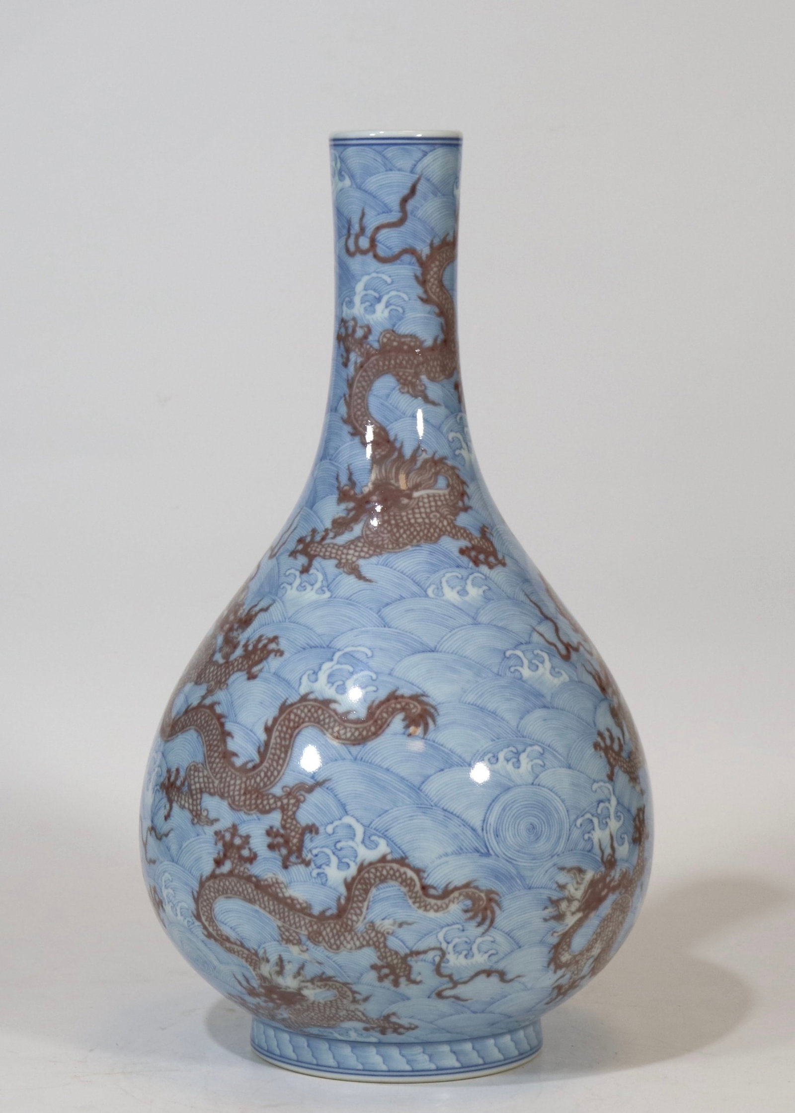 A fine blue and white underglaze red nine-dragon gallbladder vase with sea-wave pattern: A fine blue and white underglaze red nine-dragon gallbladder vase with sea-wave pattern, Qing Dynasty, China, with six-character Yongzheng reign mark, Size:15.4inx8.3in 青花海水