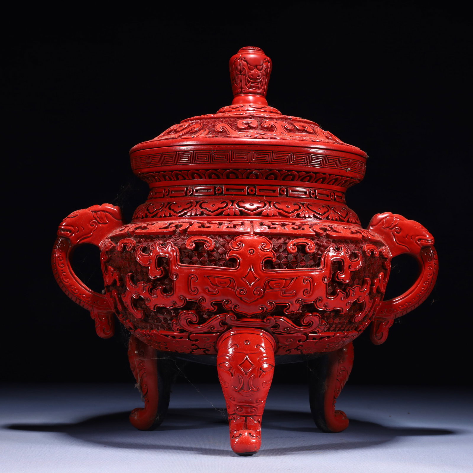 An Exquisite Carved Red Lacquer Beast-Face Pattern Double-Ears and Tripod Censer: An Exquisite Carved Red Lacquer Beast-Face Pattern Double-Ears and Tripod Censer,Qing Dynasty,China,Qianlong Four-character Mark,Size:13.8inx9.8inx15in,Weight:3950g 剔红漆兽