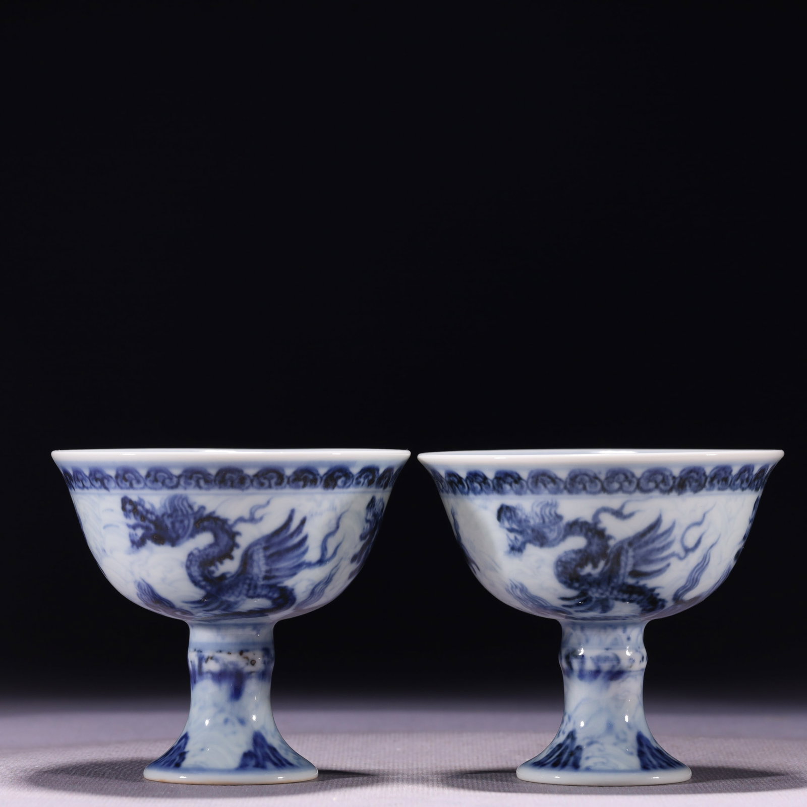 A Pair of Exquisite Blue and White Seawater and Dragon Pattern Stem Cups,With Sanskrit: A Pair of Exquisite Blue and White Seawater and Dragon Pattern Stem Cups,With Sanskrit,Ming Dynasty,China,Xuande Six-character Mark,Size:3.2inx3in,Weight:183g 一对青花海&