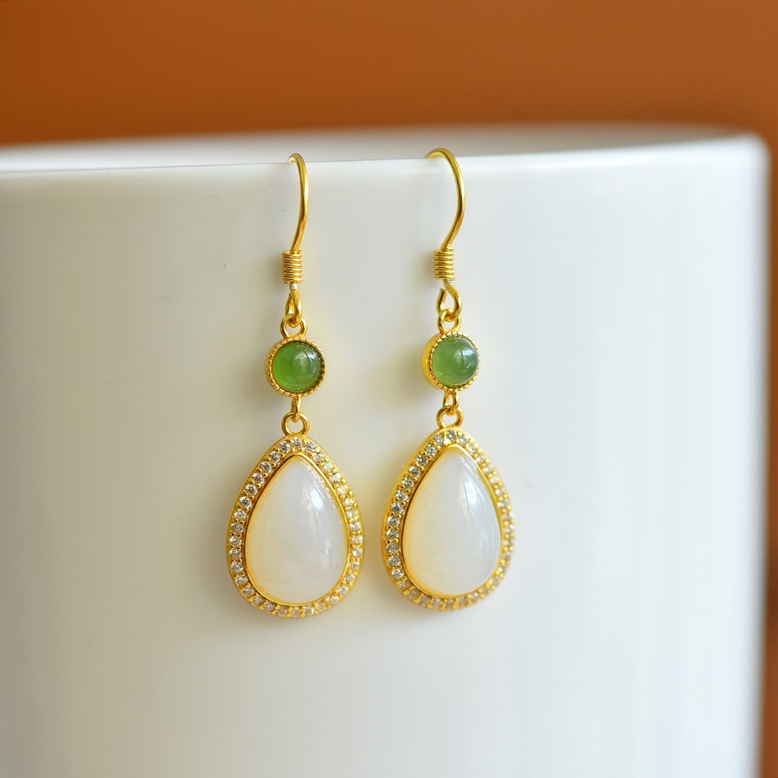 A Pair of Sterling Silver and White Jade Drop Earrings: A pair of sterling silver drop earrings, each set with a white jade drop, Sise: 8mm×12 mm.