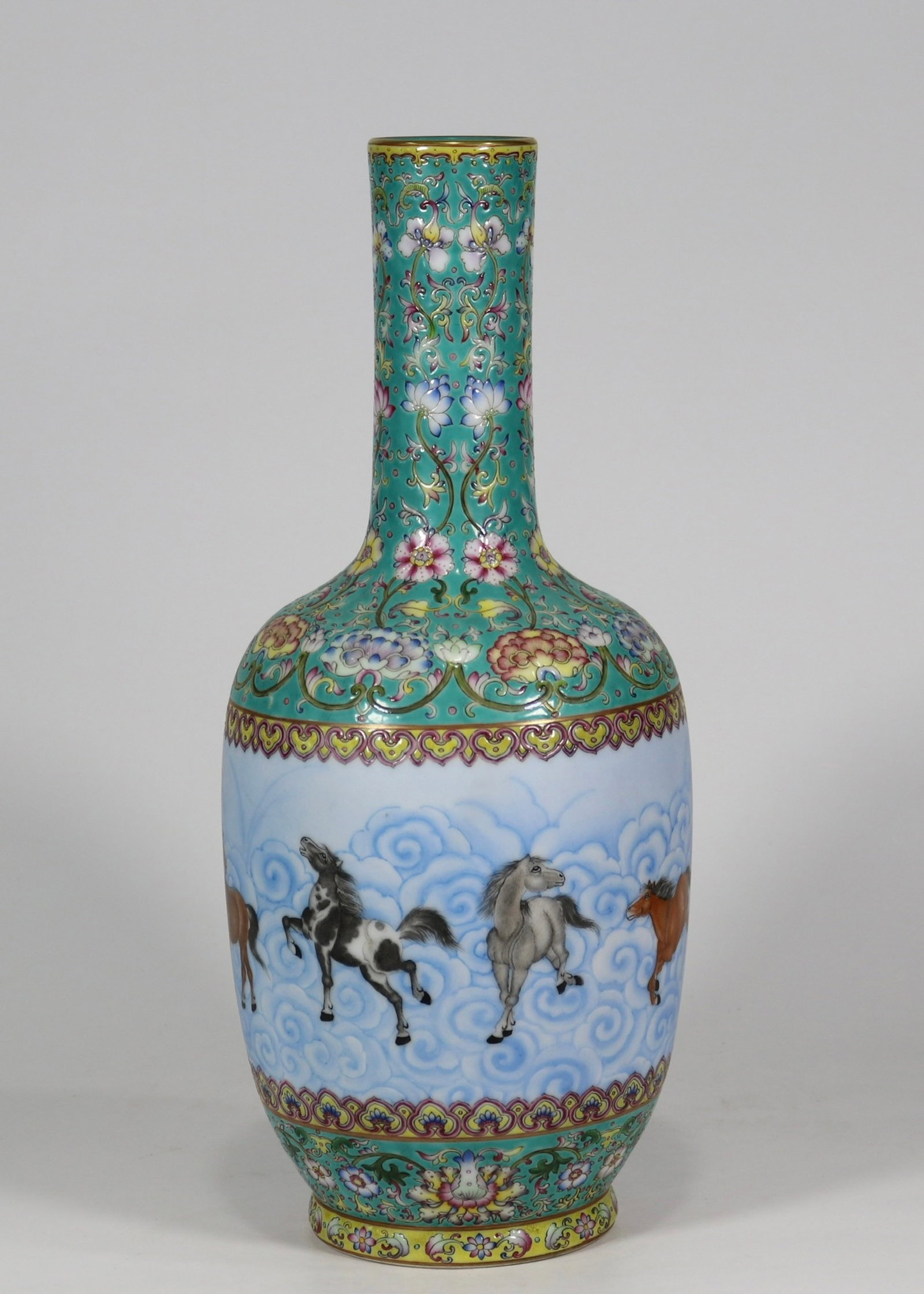A fine turquoise blue ground long-necked vase with reserved eight horses panel: A fine turquoise blue ground long-necked vase with reserved eight horses panel, Qing Dynasty, China, with six-character Qianlong reign mark, Size:15inx2.3in