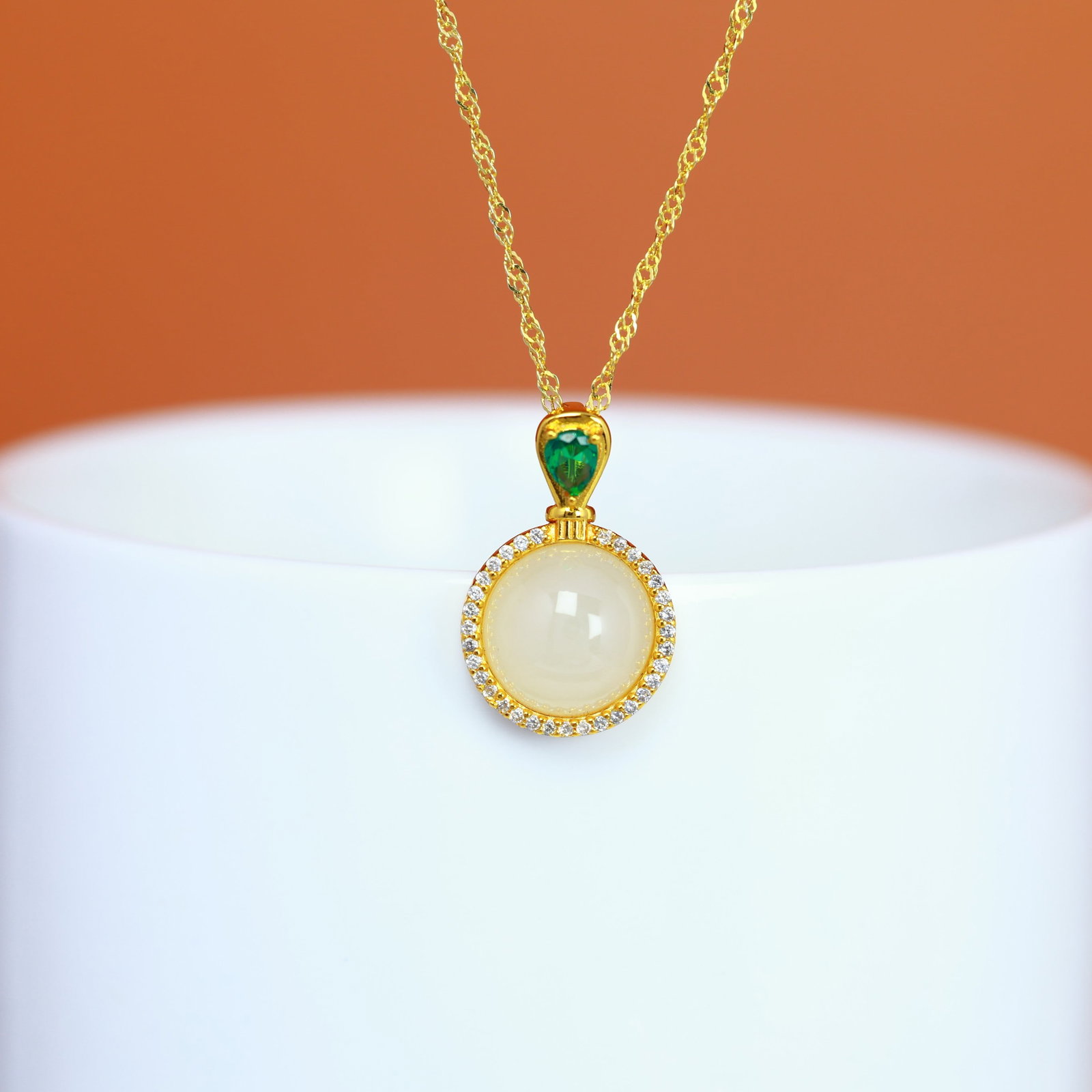 A Sterling Silver and White Jade Round Cabochon Pendant: A sterling silver pendant set with a round white jade cabochon, Sise: 9mm×9 mm.