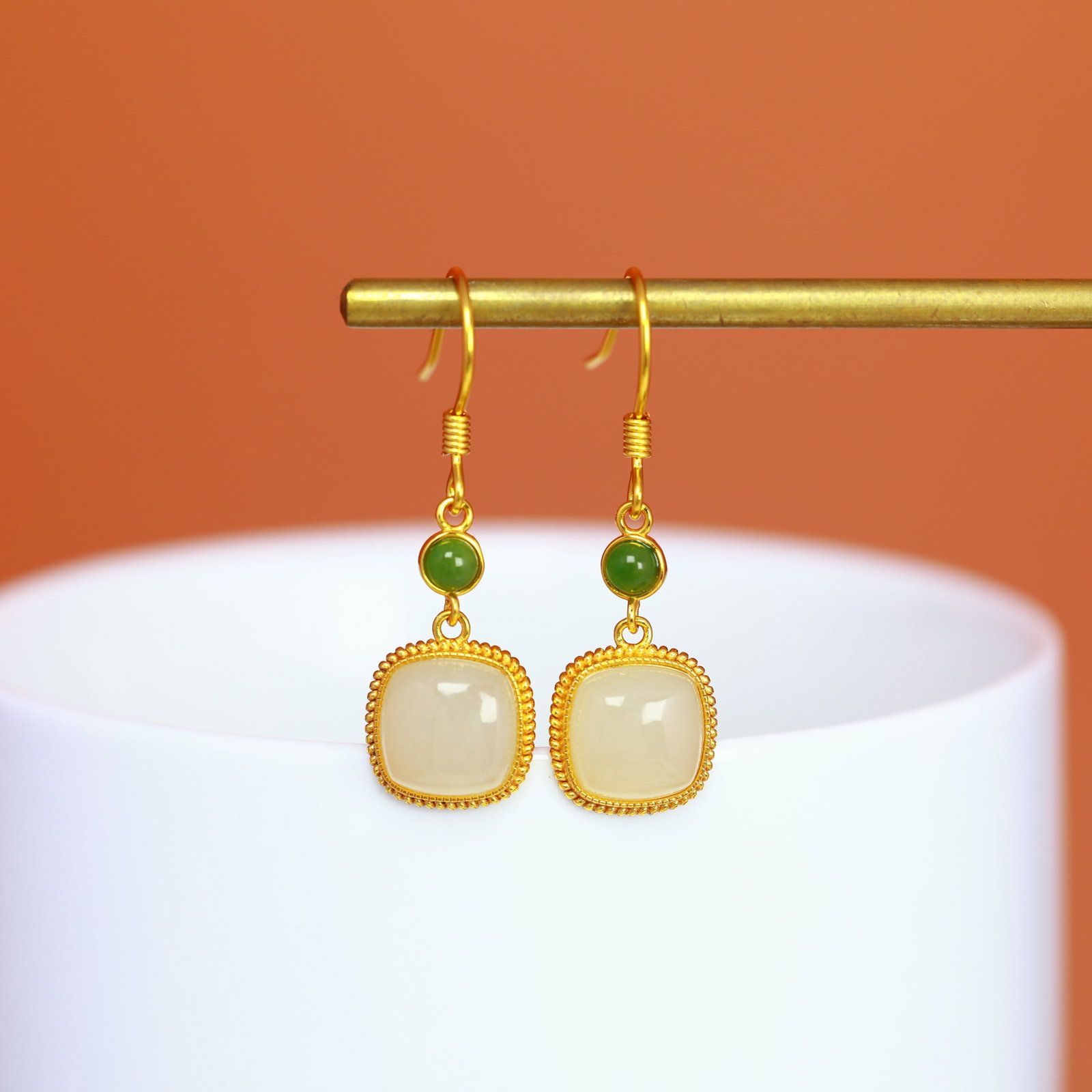 A Pair of Sterling Silver and White Jade Square Drop Earrings: A pair of sterling silver drop earrings, each set with a white jade of square form, Sise: 8mm×8 mm.