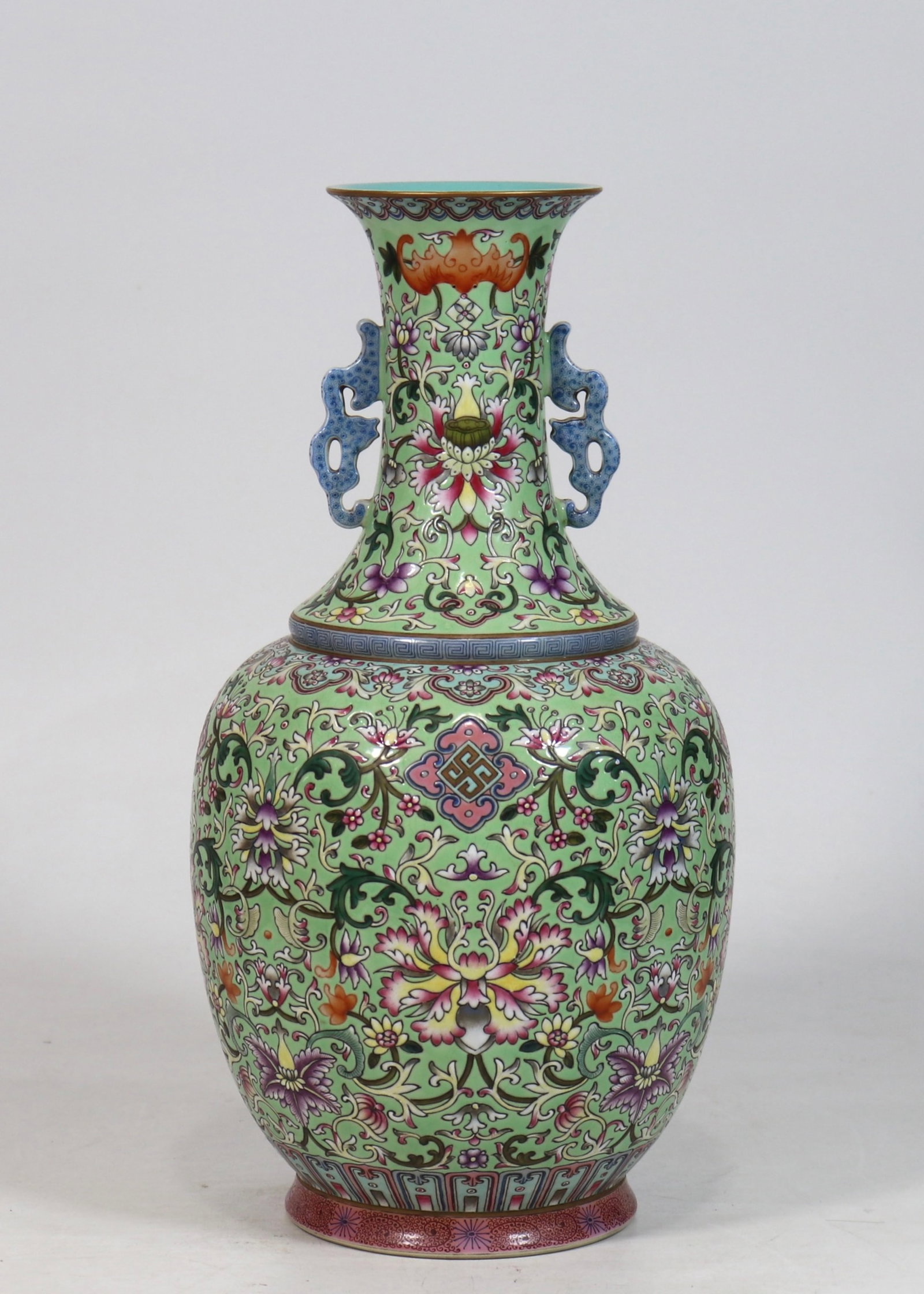 A fine green-ground double-handled vase with scrolling floral pattern: A fine green-ground double-handled vase with scrolling floral pattern, Qing Dynasty, China, with six-character Qianlong reign mark, Size:13.3inx6.5in 绿底缠枝花卉&#