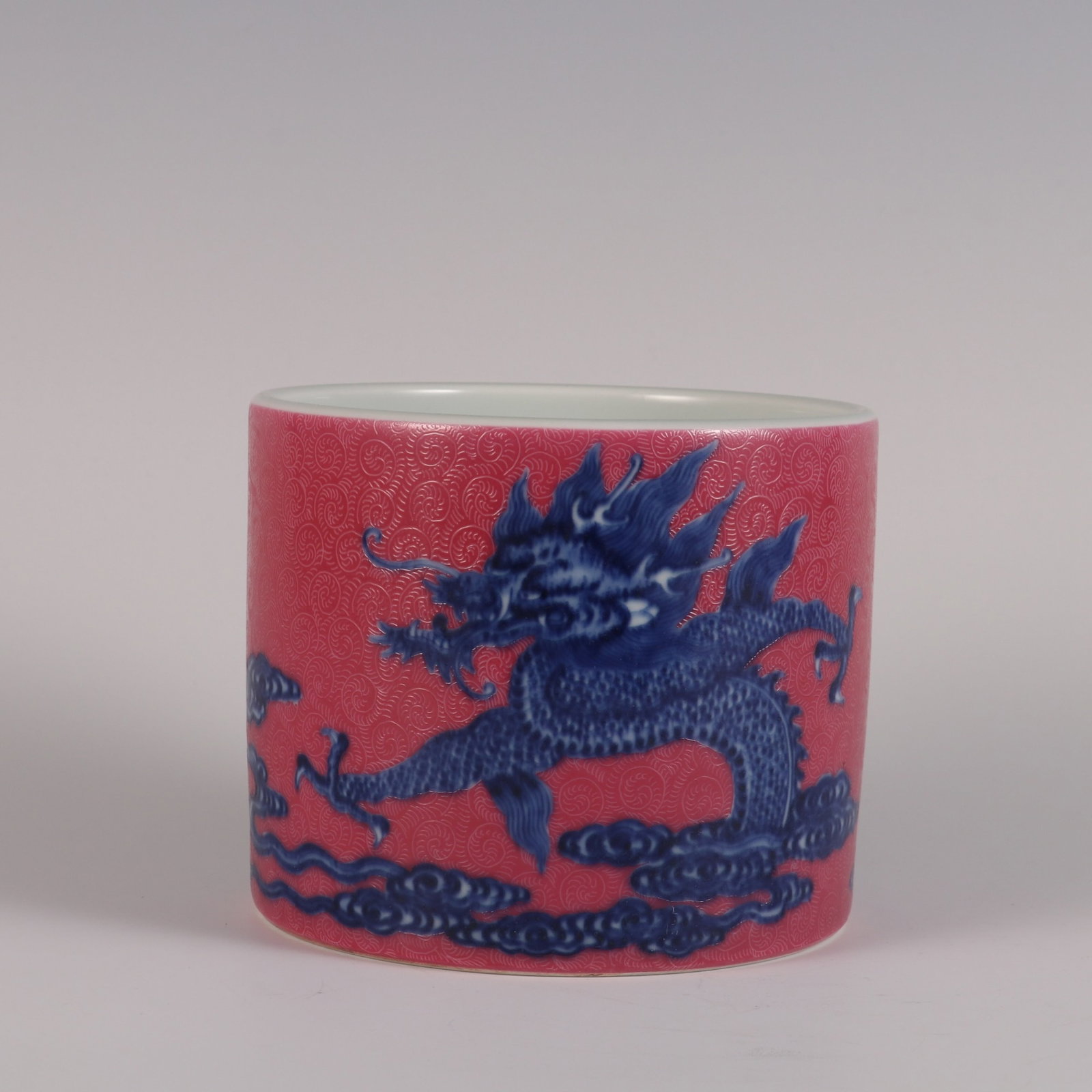 An Exquisite rouge red ground sgraffiato blue and white cloud dragon brush pot,: An Exquisite Jiaqing reign Qing dynasty rouge red ground sgraffiato blue and white cloud dragon brush pot,Qing Dynasty, China,Jiaqing Six-character Mark,Size:3.9inx4.8in,清嘉庆ॲ