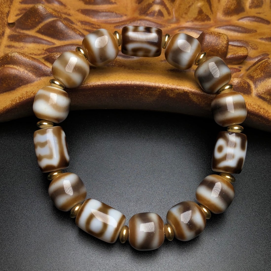 An Exquisite Old Material Multi-Stone Dzi Bracelet: An Exquisite Old Material Multi-Stone Dzi Bracelet. Rich oily patina, clear totems, fine orange-peel texture, mellow coating. Size 12mm×11mm to 15mm×11mm. 一件老料