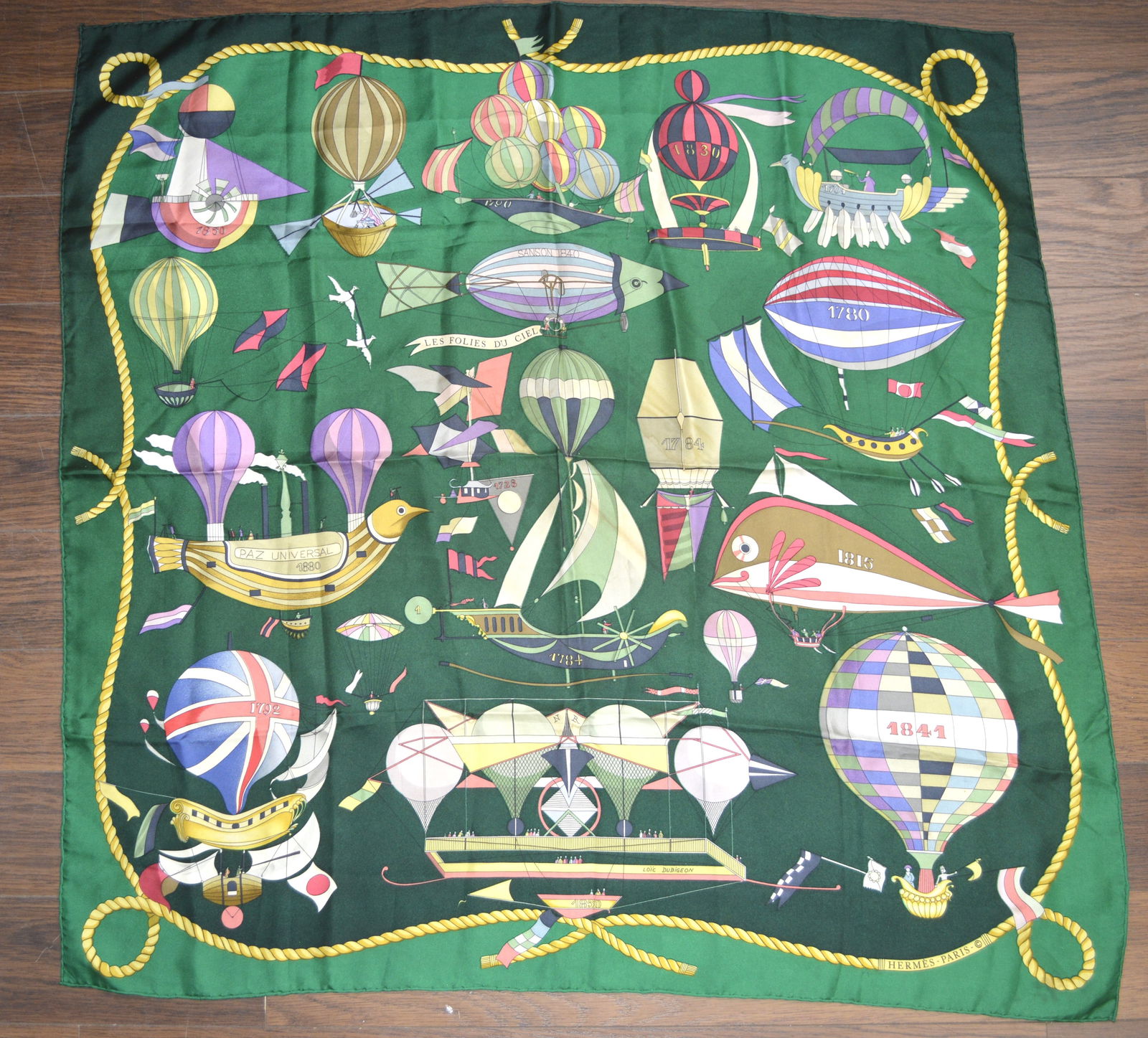 Hermes Silk Scarf titled "Les Folies Du Ciel", designed by Loic Dubigeon: Hermes Silk Scarf titled "Les Folies Du Ciel", designed by Loic Dubigeon, and dated 1984 Silk twill with hand-rolled edges (100% silk) Measures: 35 inches square