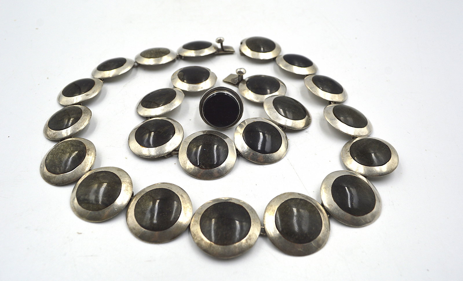 Taxco Set of Sterling Silver and Onyx Jewelry: Taxco necklace, bracelet and ring set. Stone is onyx or jet Signed markings: 925 Sterling Silver Measurements: Necklace: 16 inches long Bracelet:7 inches long Total weight: 112 grams