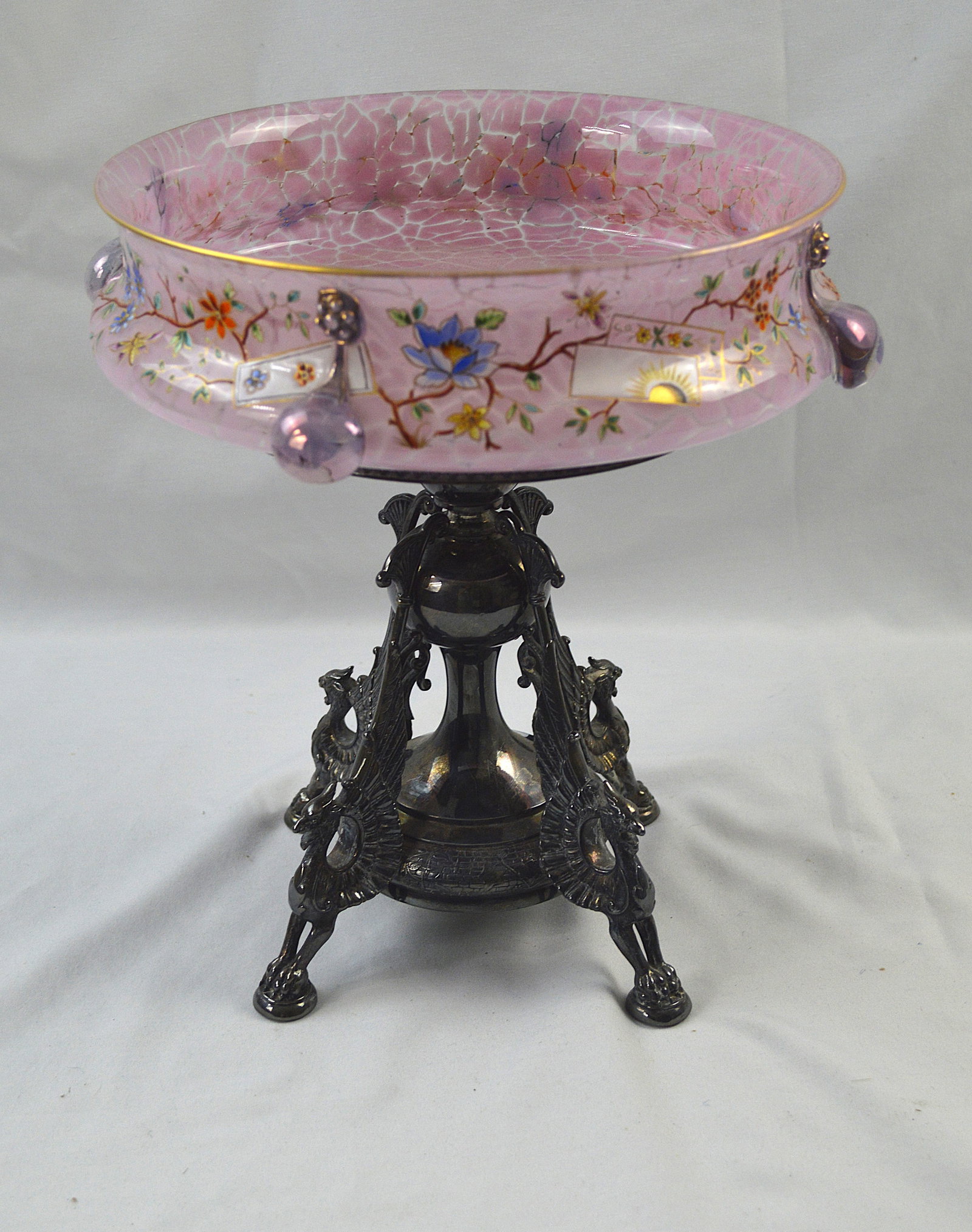 Enameled Glass Aesthetic Centerpiece: Enameled Glass Aesthetic centerpiece. Circa 1890s “Aesthetic” movement Base plated by Reed and Barton #3855 Measures: height (including plated stand) 11 inches, Pink bowl top 9.5 inch diameter