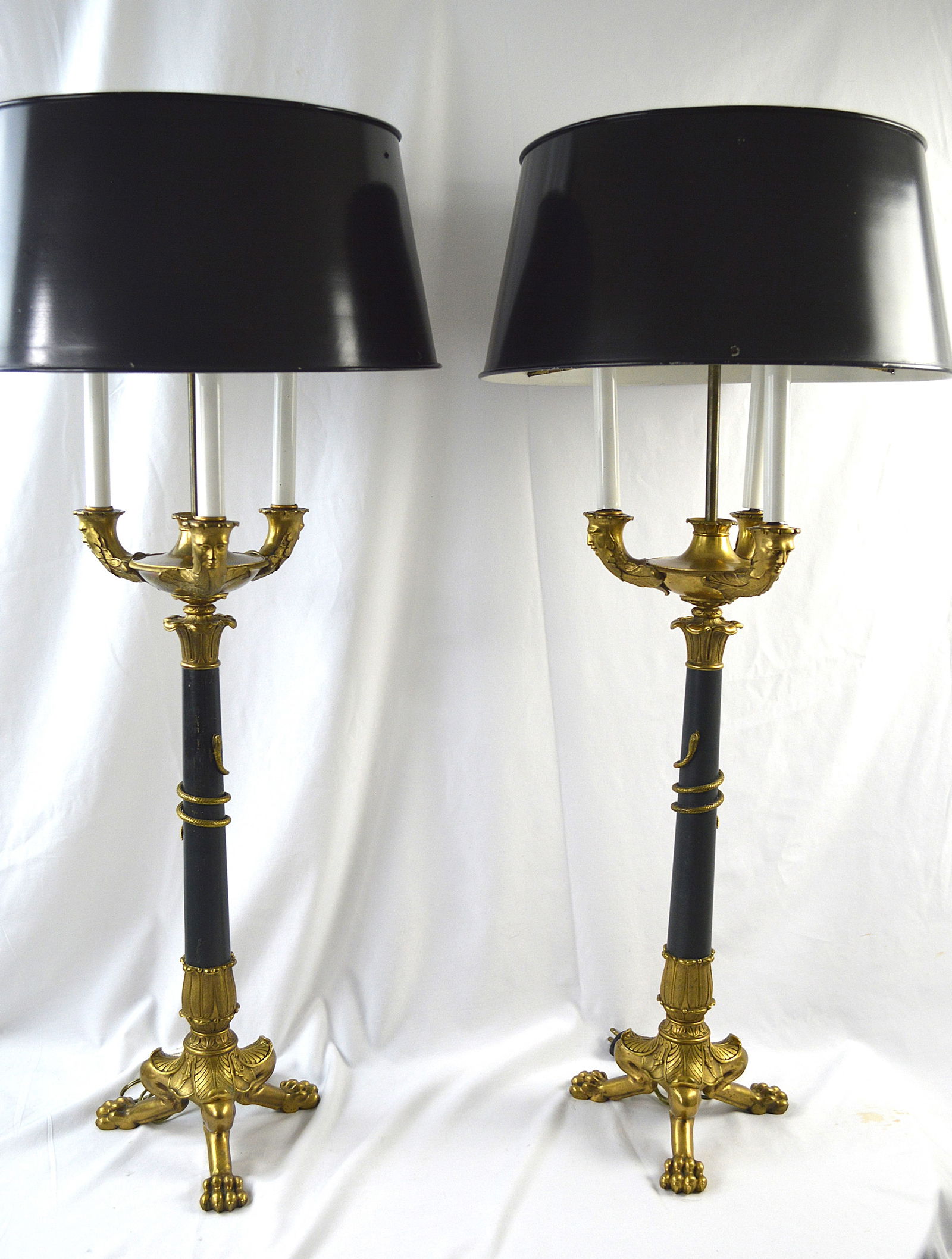 Pair of Empire Period Gilt Bronze Candelabras: Pair of antique Napoleonic gilt bronze candlesticks with later electrification. Later tin and brass shades. Total height each: 36 inches high