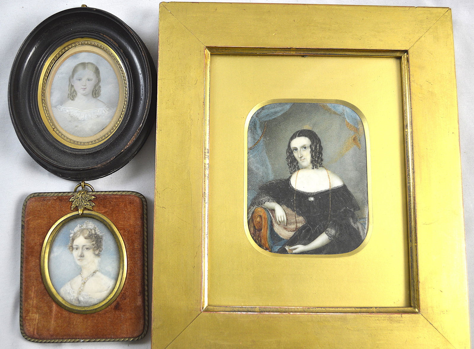 Three Miniature Portraits: 3 miniature portraits of three ladies; old English Measures: Velvet frame: 2.75 inches in height Wooden frame with oval inset: 2.75 inches in height Large gilt frame: 4.25 inches high