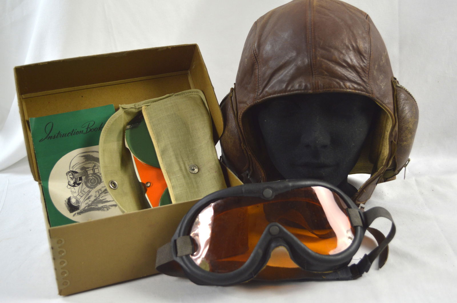 Aviators Helmet and Glasses: Details: Canadian WW2 Leather pilot's helmet and glasses. Helmet is signed by battalion pilots. Aviator glasses are in original box with many different coloured replacement eyeglasses. Does not includ
