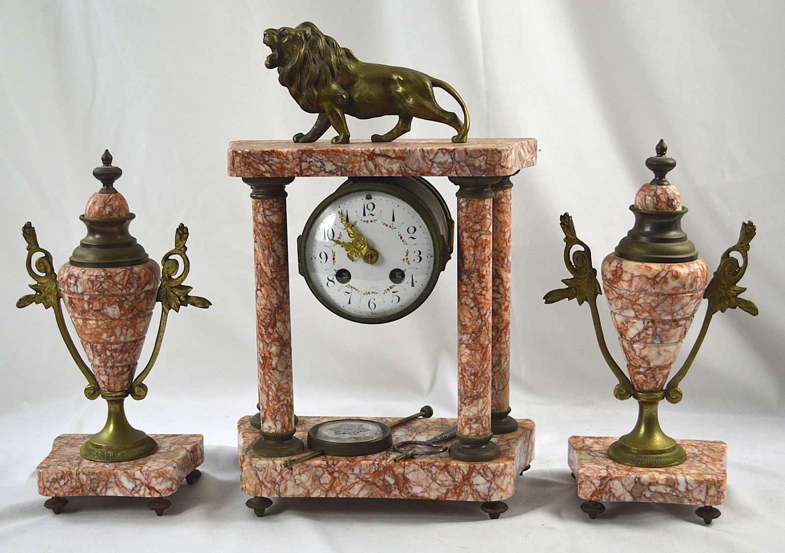 French Antique Marble Garniture set: Three piece antique marble, garniture set with a circular porcelain painted dial.