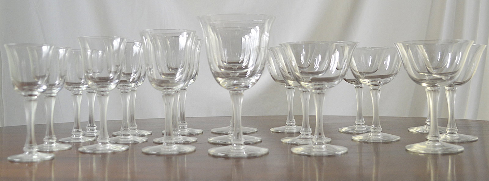 Lalique signed Stemware: Total of 21 pieces of Lalique signed glass, stemware. 4 sizes: 3 red wine, 8 champagne flutes, 4 juice glasses, 7 liqueur glasses. Largest is 6 inches high by 4 inches diameter, and smallest is 3 inch