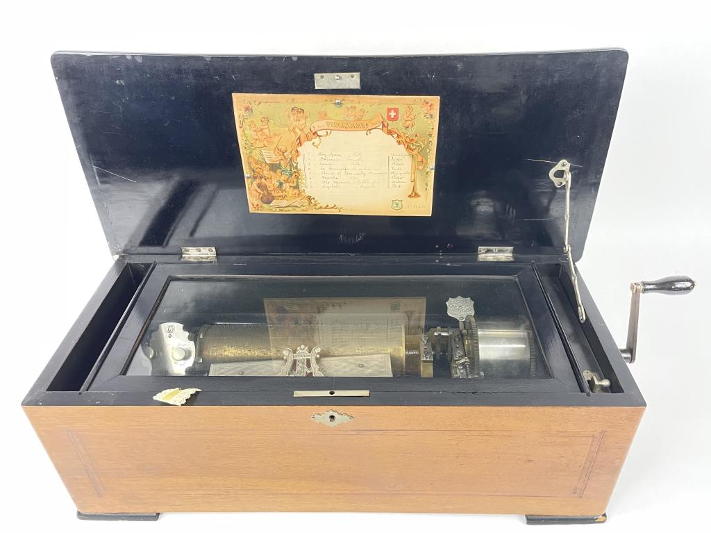 Antique Mermod Freres Swiss Music Box (Working): 21" W x 7" T x 9" D Case is in good condition with a minor chip to the wood on the lid. Movement is working. The slow/fast lever works but in won't stay in the fast position.