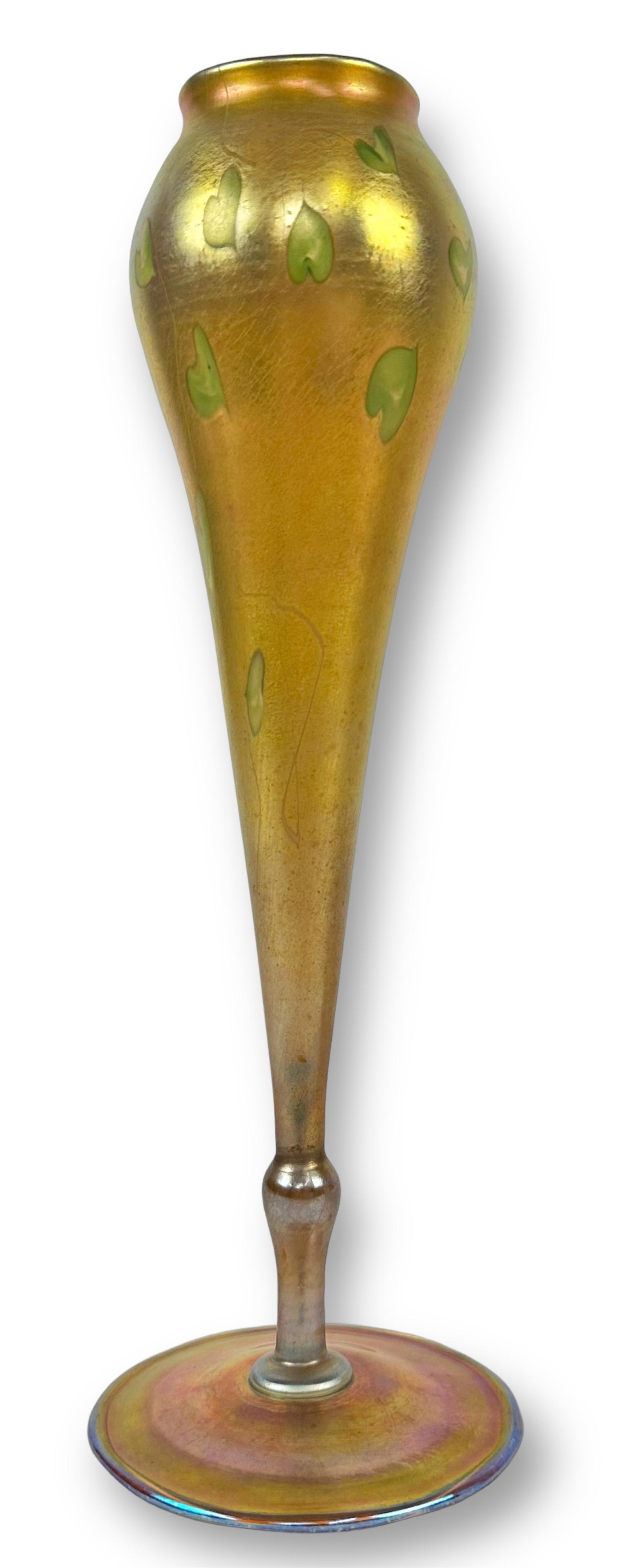 LCT Tiffany Intaglio Heart & Vine Favrile Vase: Marked "L.C. Tiffany-Favrile 3021 E" at the bottom. Height: 12" Condition: Good with no issues seen. Developed by Louis Comfort Tiffany (1848-1933), Favrile glass is an iridescent art glass that was u