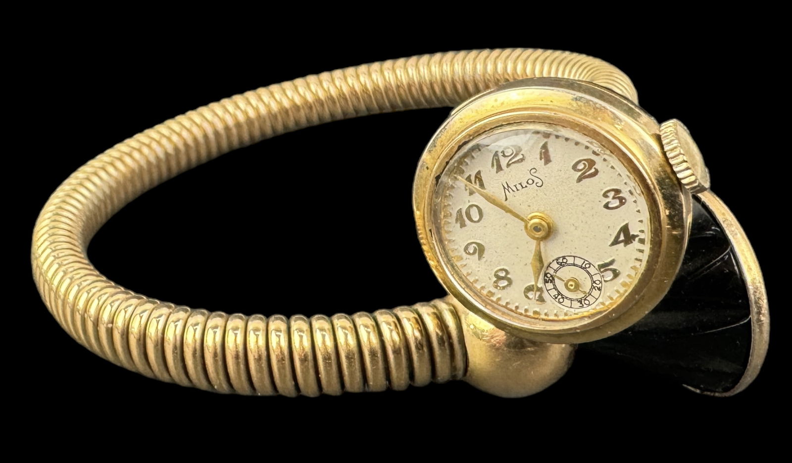 Vintage Bakelite Milos Wrist Watch/ Bracelet: Size: Watch face is 3/4" across and band is 1/4" across Condition: Minimal surface scratches consistent with age and use. Watch is monogrammed. See photos.