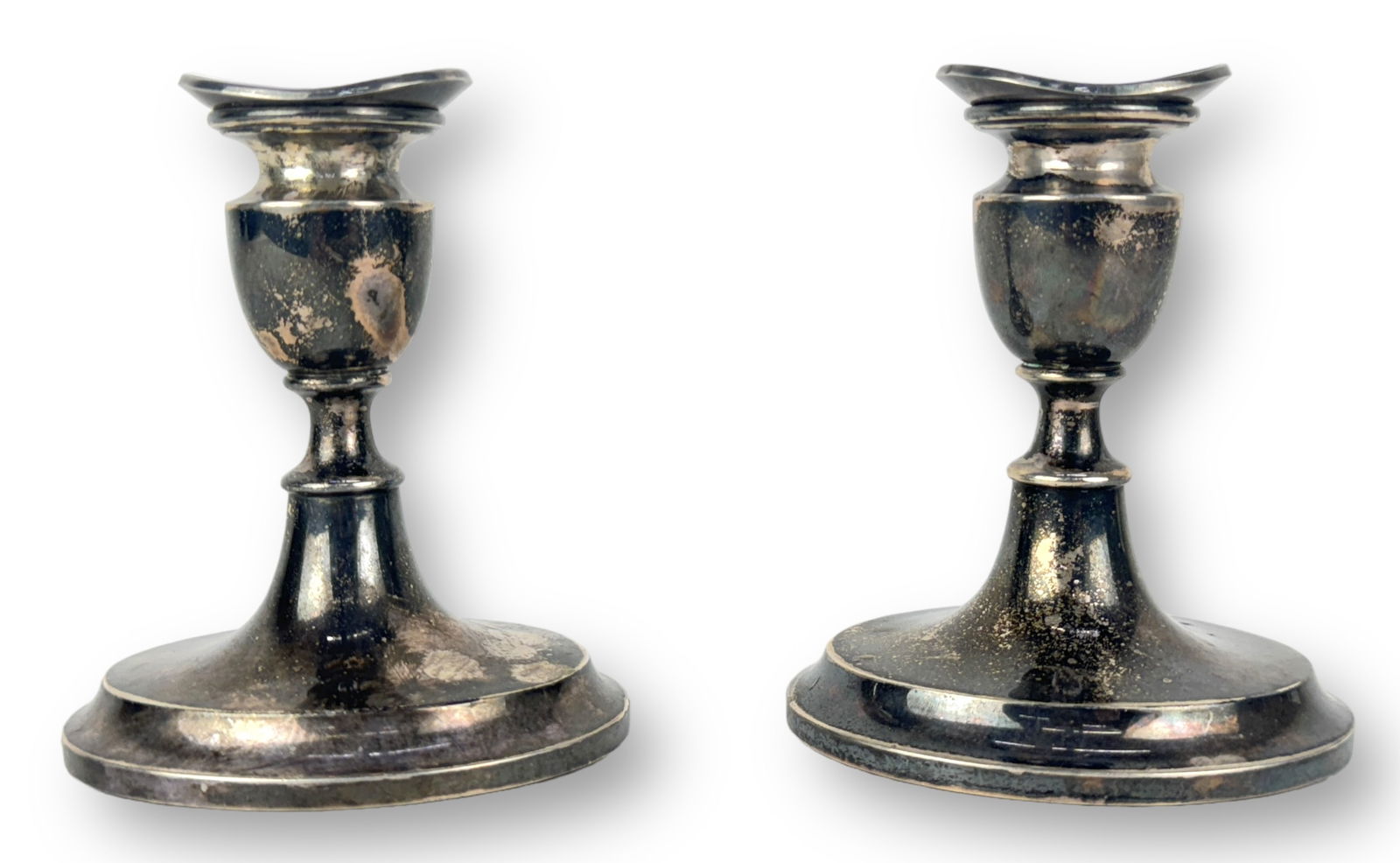 (2) Svend Toxvaerd 830 Silver Candlesticks: Size: 4 1/2" tall x 3/78" long x 3 1/4" wide Condition: Tarnishing and surface scratches consistent with age and use.