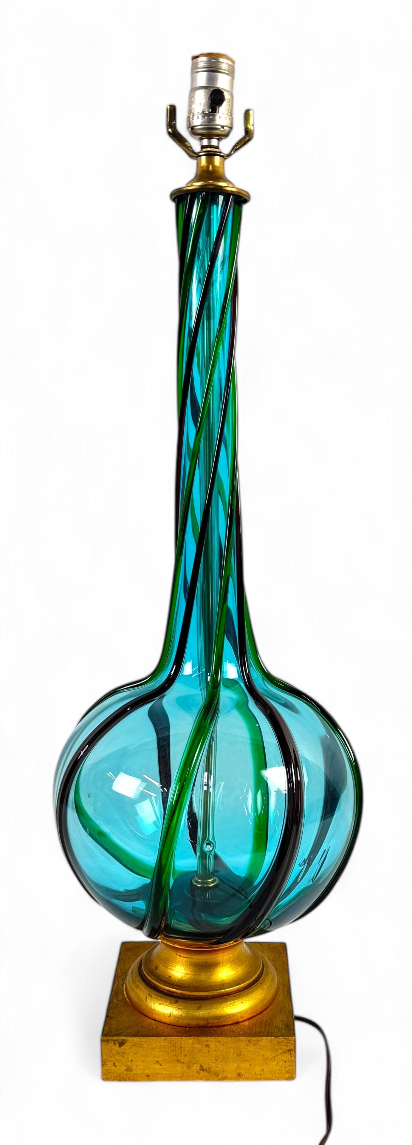 Murano Blue & Green Glass Lamp 1950s: Navy & green raised rope twist lamp with gold wood base Dimensions: 31 1/2" x 10" Condition: lamp is in working condition, minor surface marks on base.