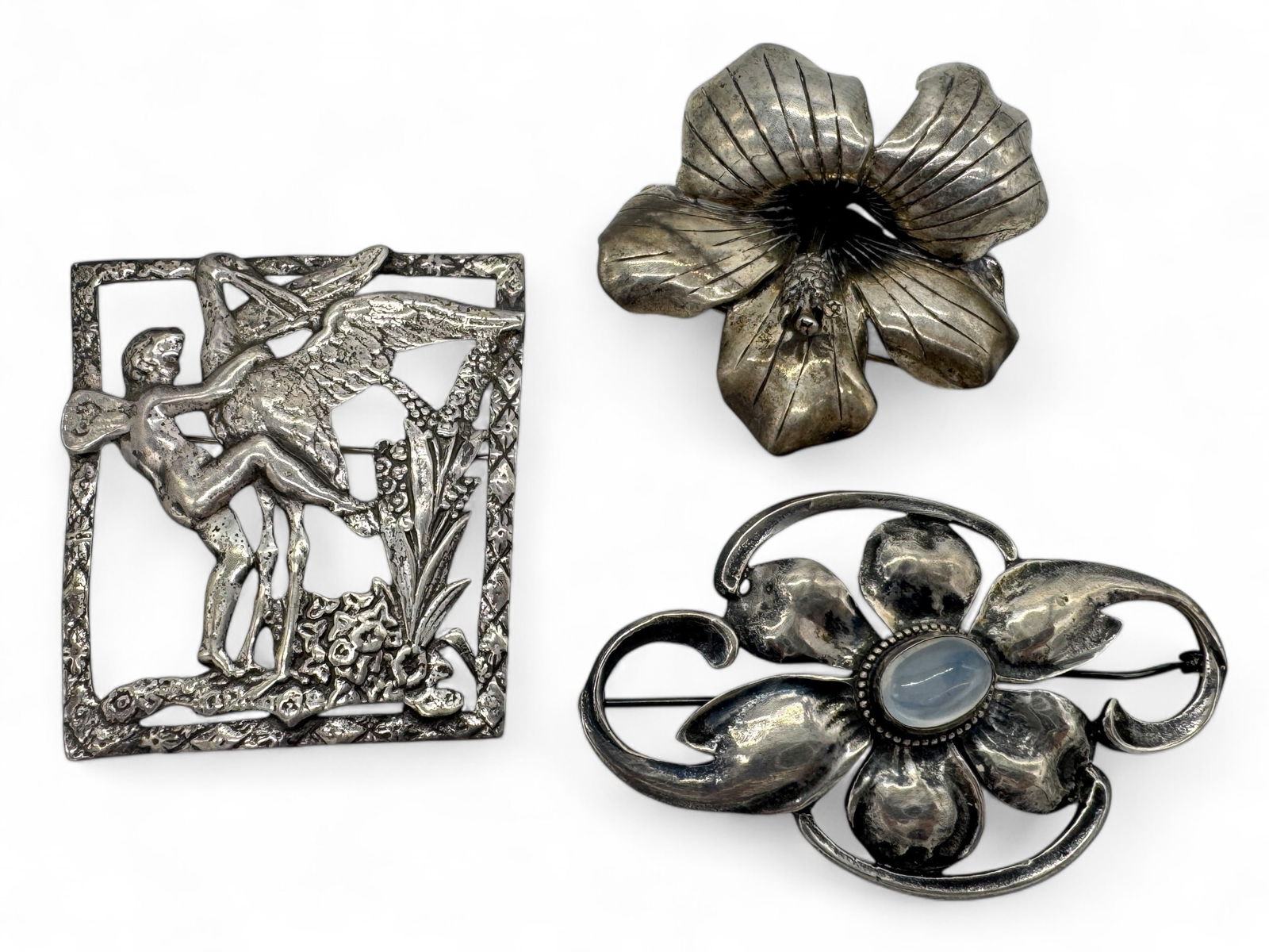 (3) Coro & Vappelli Ect 1940s Sterling Jewelry: (3) marked sterling brooches, flower pin marked "Finese Styled by Vapprlli", fairy pin marked "Sterling Craft By Coro", flower pin with moonstone cabochon, marked "Sterling". All (3) have hinged pins