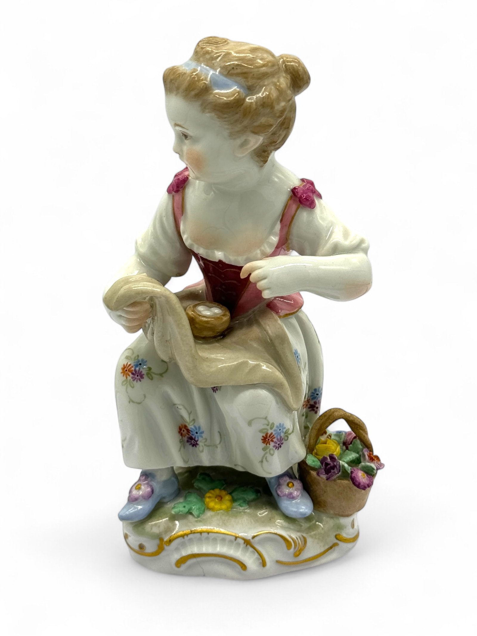 Meissen Girl With Basket of Eggs: Meissen crossed swords on the bottom. Height: 4 1/4" Condition: very good