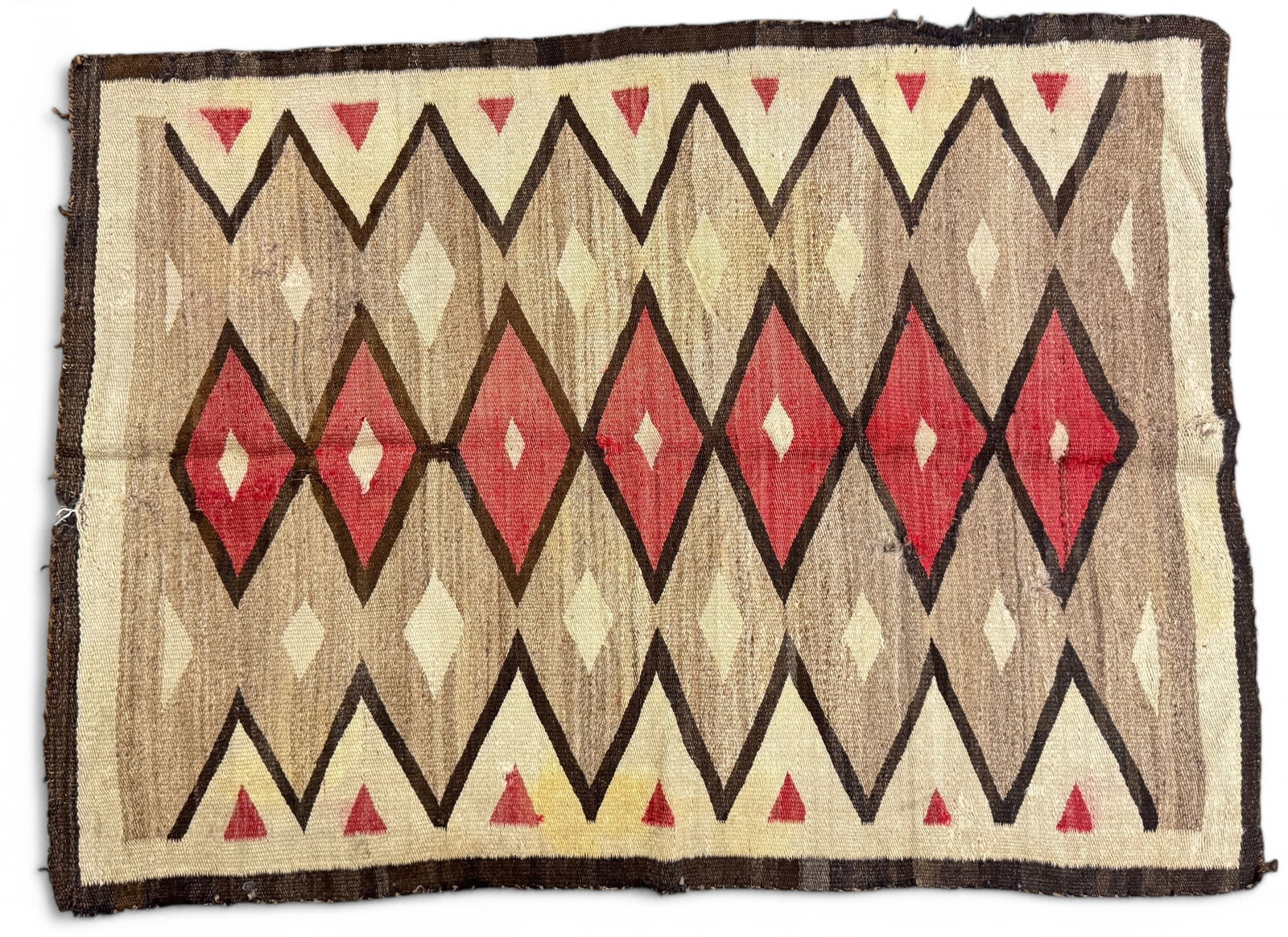 Antique Navajo Red & Brown Rug: Native American Navajo Indian Ganado, geometric diamond designs with brown, black, red, and cream colors. Size: 4' 3" x 3' 1"Condition: a few stains, two 1/2" holes,