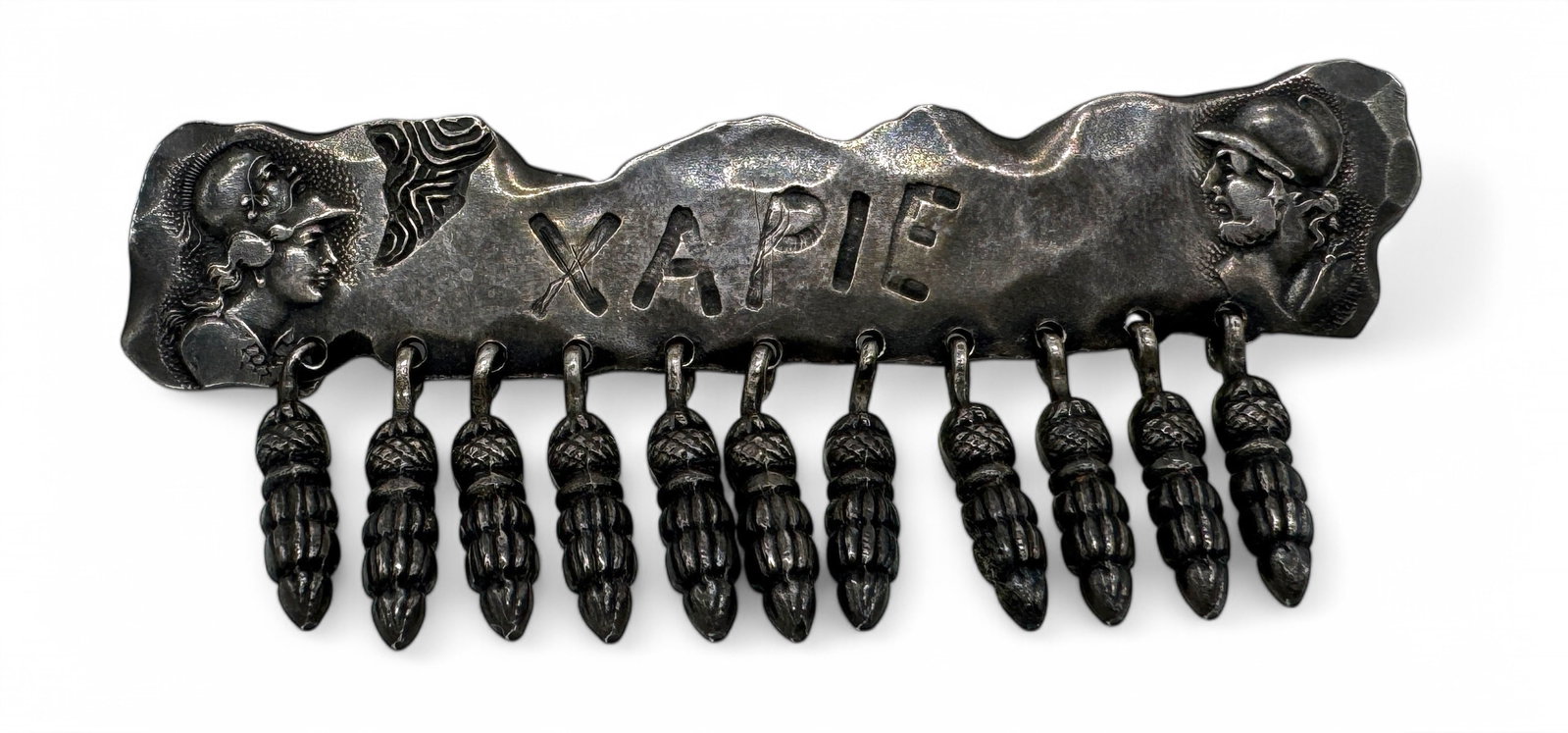 George Shiebler Etruscan Sterling 'XAPIE' Brooch: Roman motif with “XAPIE” on the front & marked with maker's mark & “STERLING 411” on the back Length: 3" Width: 1 1/8" including dangles Weight: 24.