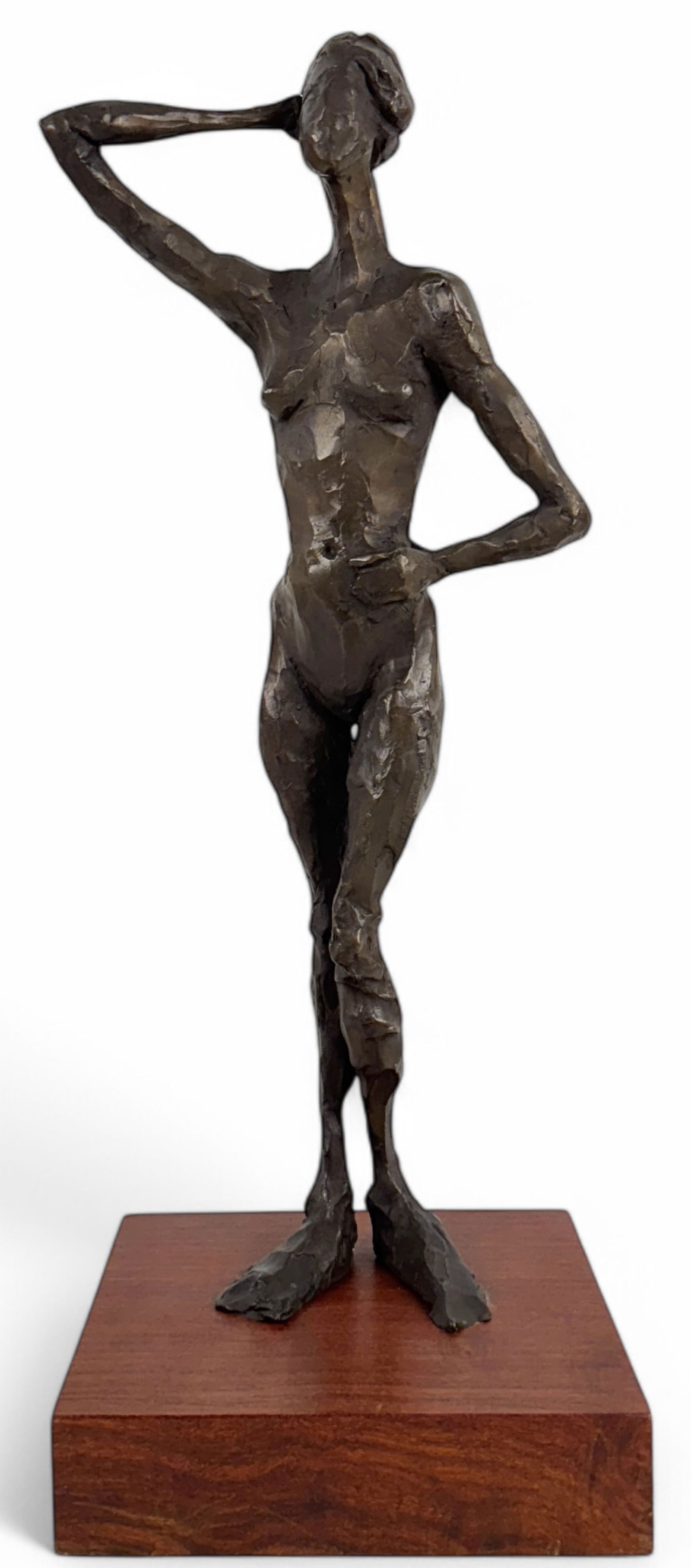 Curt Brill "Standing Pamela" Bronze Sculpture: "Standing Pamela," a bronze figure with dark patina stands with one hand on her hip and the other hand resting over the ponytail falling down her back. Signed on left foot Height: 22&qu