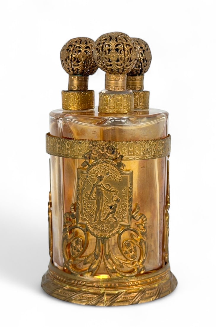 1910 Charles Fay Style "Three Muses" Perfume Tantalus: Dimensions: 5" tall x 3" diameter Condition: In good condition, with a sticker on the bottom and light patina to the gold finish. 