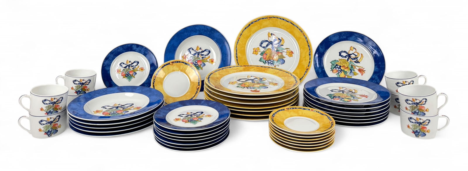 (46pc) Bernardaud French Borghese China Set: The dinner plates and cups, and saucers feature a yellow lip with a royal blue ribbon near the rim. The remaining pieces have a royal blue lip and a white well. Both styles are decorated with multicol