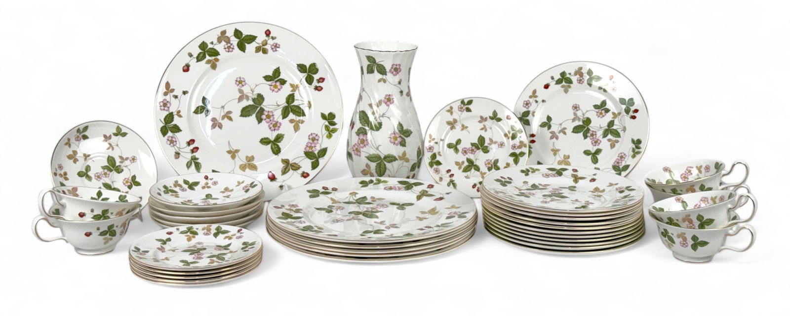 (37pc) Wedgwood Wild Strawberry China Set: White bone china with strawberry leaf and flower design and gold trim. Set includes: (6) Dinner Plates (12) Salad Plates (6) Bread & Butter Plates (6) Cups (6) Saucers (1) Flower Vase 