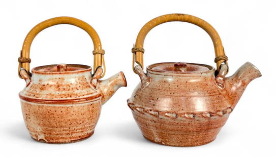 (2) Warren MacKenzie Stoneware Teapots: With Shino Glaze and bamboo handles. Unmarked. Tallest Pot: 5"T (not including handle) Condition: Both spouts have nicks to the ends, otherwise in very good condition. 