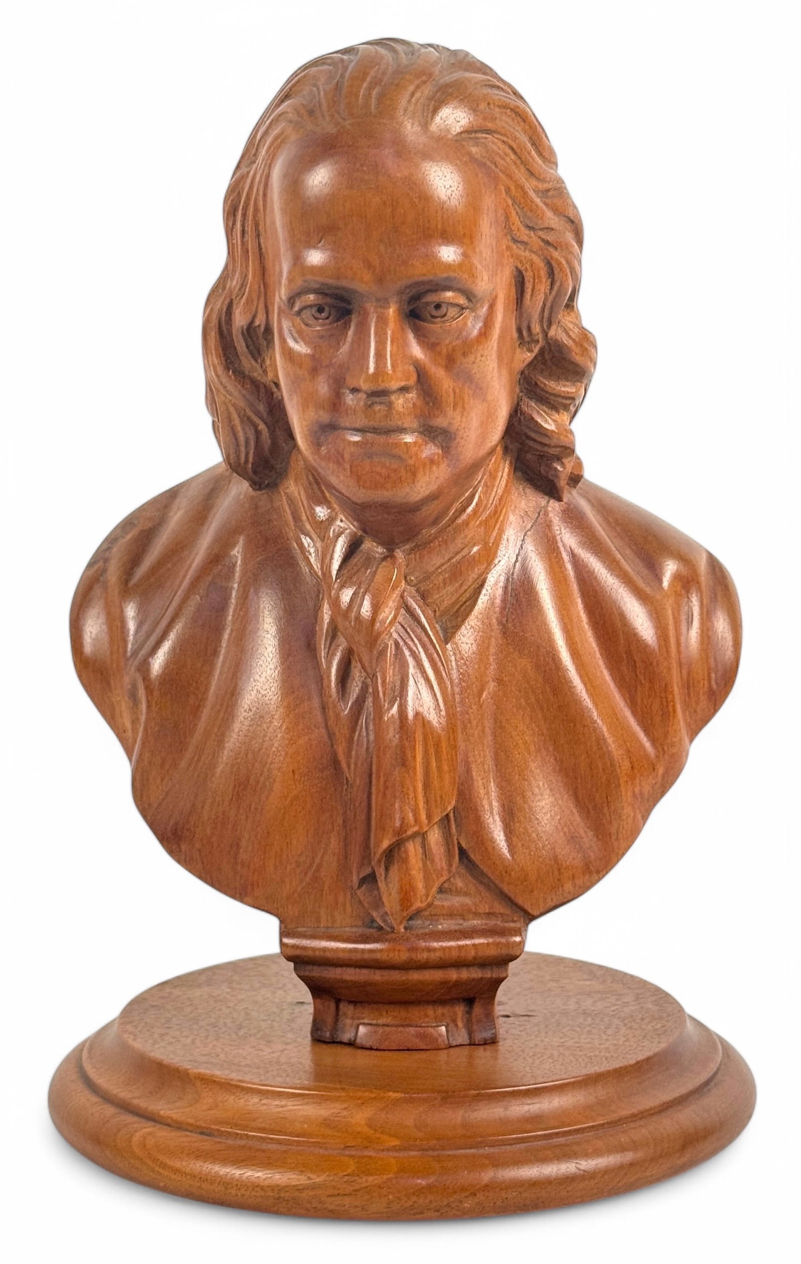 Benjamin Franklin Hand Carved Wood Bust: This carved wooden bust sits upon a round base, with the base and bust are separate pieces. Dimensions: 11" tall Condition: Very good with some light scratches consistent with age.
