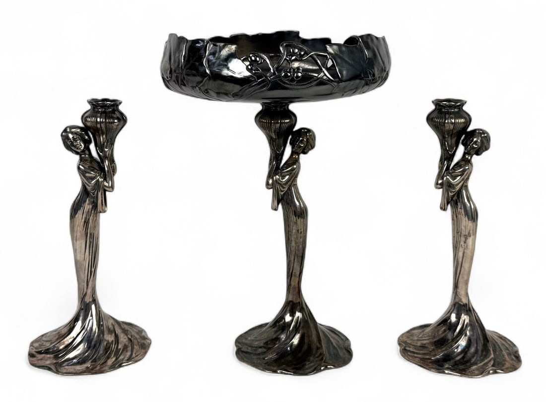 WMF Silverplate Art Nouveau Centerpiece & Candlesticks: Marked Centerpiece Height: 15" Candlestick Height: 12" Condition: Good with light scratches and tarnish consistent with age.