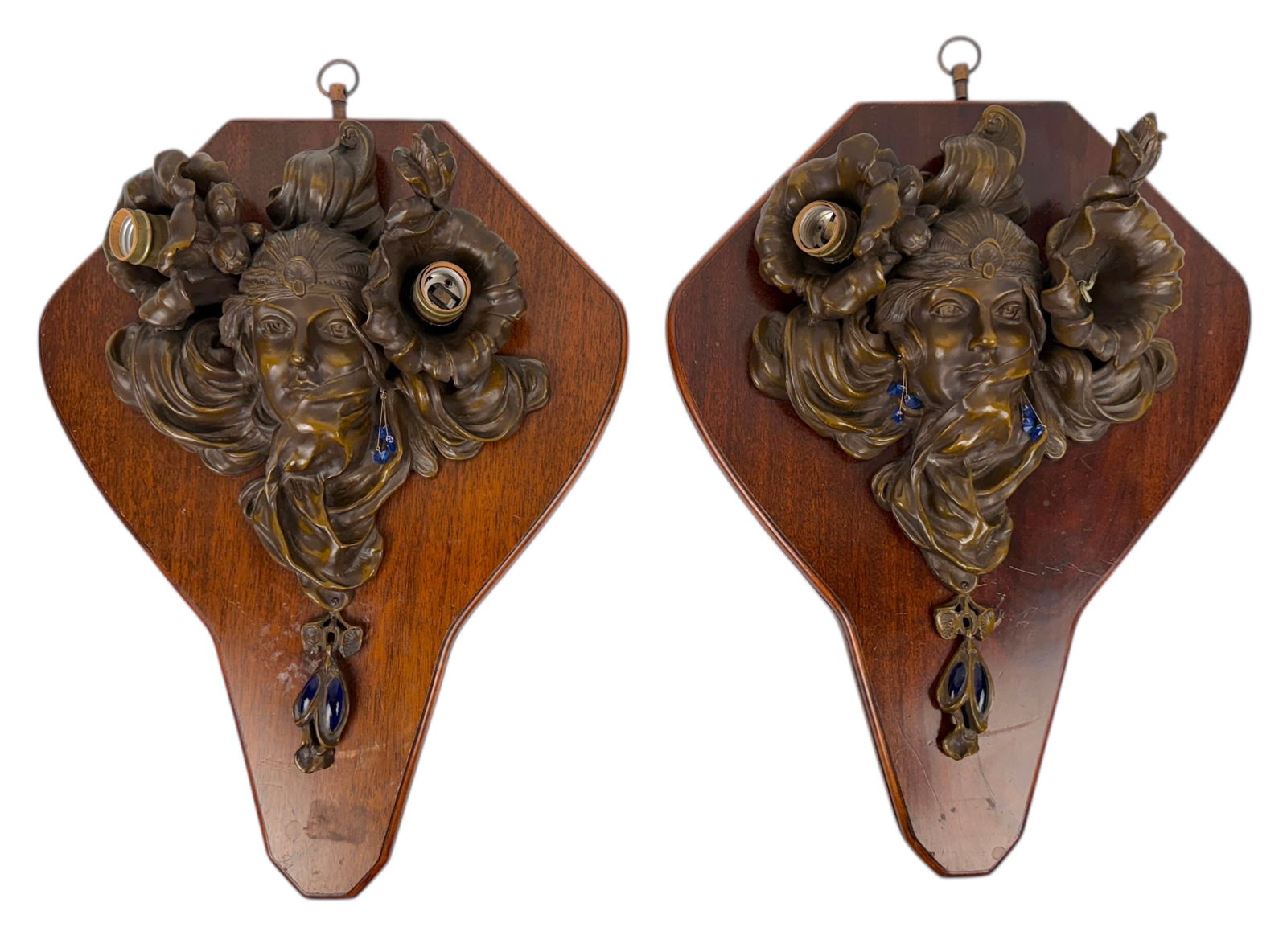 After Alphonse Mucha & Adolphe Truffler Wall Lights: Title: "The Distant Princess" Dimensions: 22" x 16" Condition: There are scratches & light markings to the wood. One is missing an earring, and the other is missing one of the