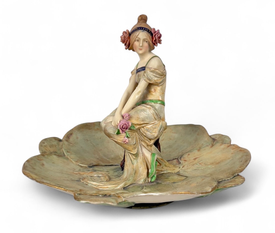 Ernst Wahliss Art Nouveau Figure Lady in Lilypads: Height: 8 1/2" Base Diameter: 4 1/2" Condition: Some hairline cracks in the base, otherwise the piece is in very good condition. About: Ernst Wahliss was a leading Aus