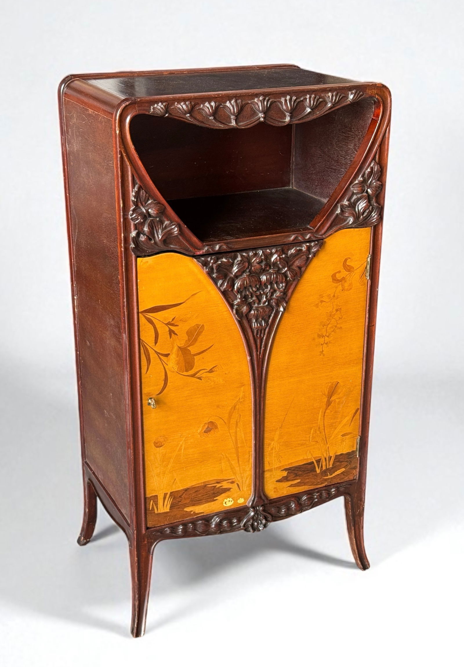 Louis Majorelle Nénuphars Marquetry Cabinet: France, c.1900, Mahogany, satinwood, rosewood, curly maple, and mixed wood inlay. Cabinet features one door and an open shelf. Includes key. Dimensions: 42 1/2"T x 21 1/2"W x 14"D Prove
