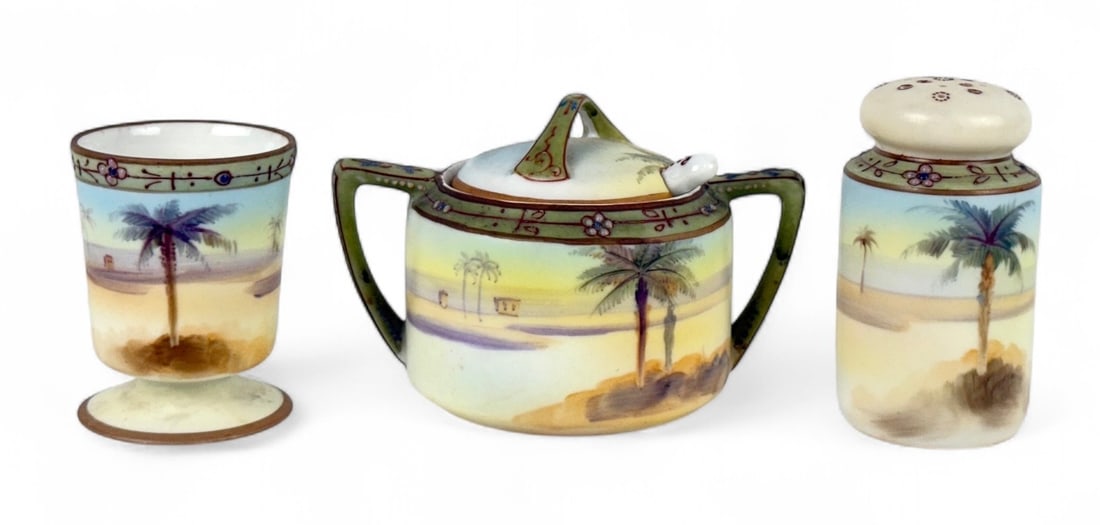 Nippon Desert Porcelain Sugar, Salt & Pepper: All are marked on the bottom and hand-painted with a Desert scene. Pepper Height: 3" Condition: Very good with no chips or cracks. The pepper is missing the cork. 