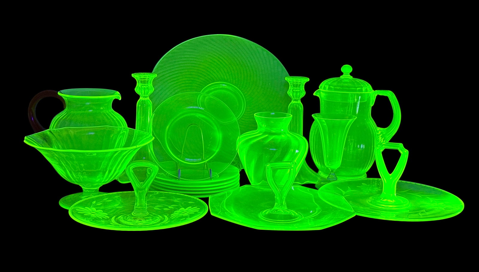 (17pc) Uranium Set Of Serving Pieces & More: (2) Pitchers (3) Handled Serving Dishes (6) Plates Bowl Platter Set Of Candlesticks Champagne Flute Vase Footed Bowl Condition: Very good with no chips or cracks. 