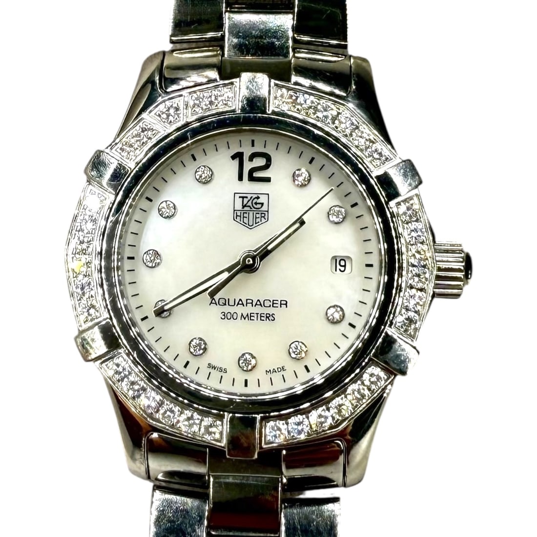 Tag Heuer Diamond Mother-of-Pearl Ladies Watch - WAG1416: Stainless Steel Aquaracer Case Size: 28mm Band Size: 8" Condition: Very good, with light scratches consistent with wear. In working condition.