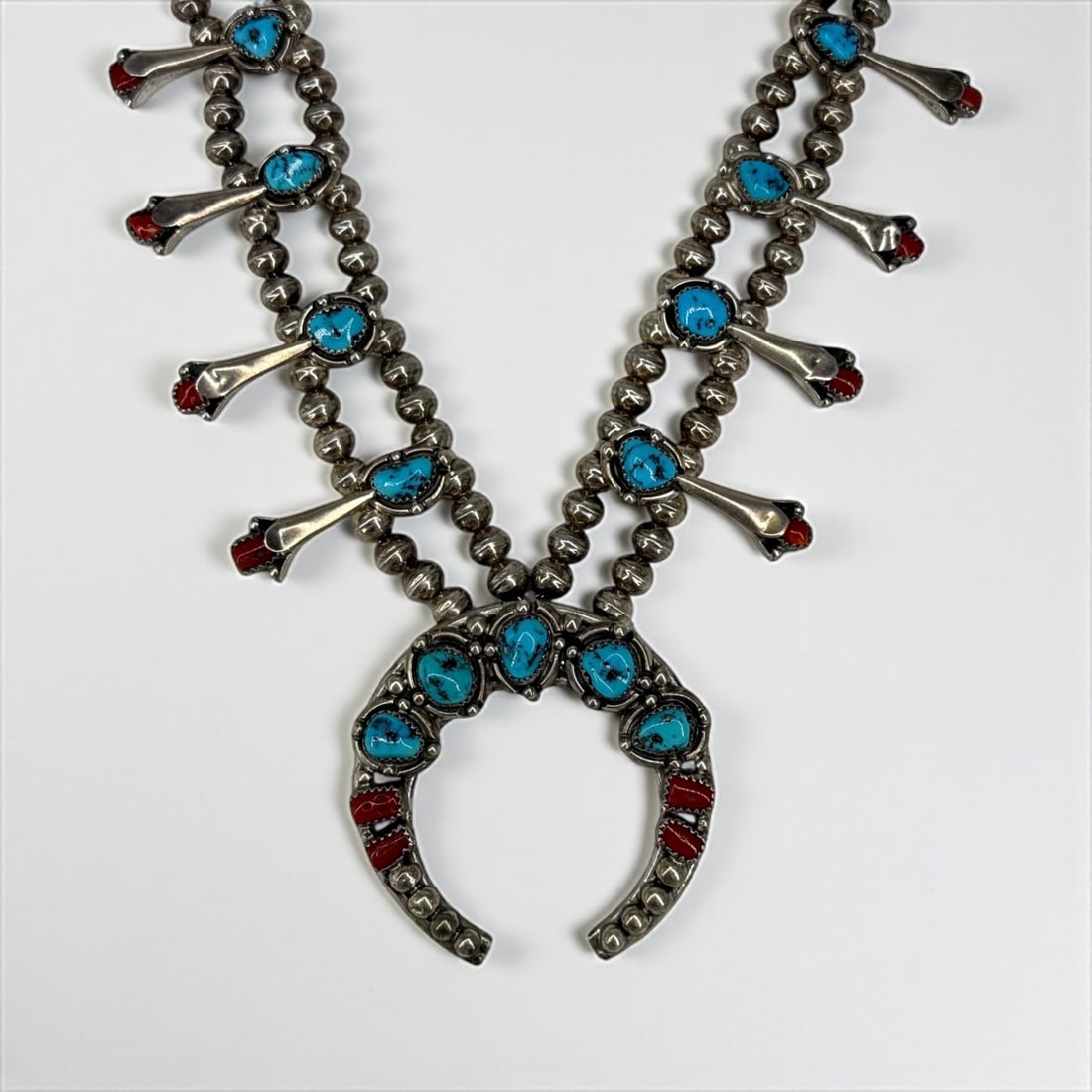 Navajo Silver Turquoise & Coral Squash Blossom Necklace: Length: 23" Weight: 85g Condition: Light tarnishing and minor surface wear consistent with age and use. Overall in very good condition.